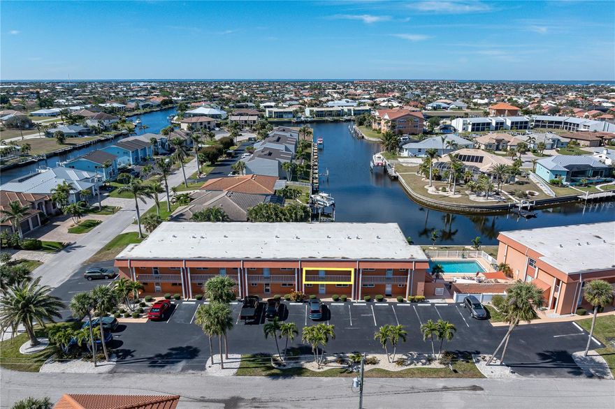 RENOVATED WATERFRONT CONDO IN PGI W/SUNSET VIEWS & QUICK BOATING ACCESS - Discover this completely rebuilt and move-in ready 2 bed/2 bath condo in Punta Gorda Isles, offering spectacular canal views, western exposure for nightly sunsets, and first-come, first-serve dockage. With most furnishings included, this residence is ideal for seasonal living, downsizing, or as an investment. Inside, the open-concept floor plan showcases a beautifully updated kitchen with stainless steel appliances, stone countertops, turquoise glass tile backsplash, and stacked washer/dryer tucked conveniently nearby. The spacious living area opens seamlessly to the screened lanai, creating an effortless indoor-outdoor flow. A wall of closets in the main living area provides ample storage, while a large lanai storage closet adds practicality. Both bedrooms feature en-suite baths. The primary suite offers three closets — including a walk-in — plus direct lanai access to enjoy the view. The screened lanai boasts a stunning down-the-canal view combined with a coveted western rear exposure for breathtaking sunsets. Driftwood Condominiums offers a heated pool with shaded seating, expansive sun deck, BBQ area, and outdoor dining space—perfect for entertaining. Docks are available on a first-come basis, with openings currently available, allowing you to keep your boat right behind your unit. Reach Charlotte Harbor in minutes. Assigned parking and ample guest parking add convenience. Living in Punta Gorda Isles means enjoying quick access to waterfront dining, boutique shopping, and year-round events at Fishermen’s Village, waterfront parks or in the historic downtown area. Miles of sidewalks throughout PGI connect you to nearby parks, nature trails and the harbor walk. New to the area? Consider joining the Isles Yacht Club or the PGI Civic Association (PGICA) - they offer a variety of social clubs and activities. Move-in ready and low-maintenance, this condo is perfectly positioned to enjoy the best of Florida’s active, waterfront lifestyle. Make an appointment today.