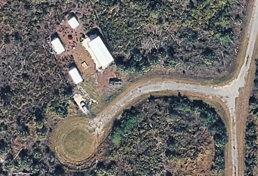 Rare opportunity to own a cleared 0.3362-acre parcel in the southeastern corner of Sarasota County, just steps from the DeSoto County line and conveniently located near Exit 170 off I-75. Tucked away on a quiet cul-de-sac, this property offers exceptional privacy and flexibility for a wide range of uses. The lot is fenced on three sides with a 6-foot decorative black chain-link fence, featuring a #57 stone driveway and a 40' x 20' crushed shell pad, ideal for a patio, trailer, or RV setup. A 10' x 10' Smith-built storage shed, approximately three years old, adds immediate functionality. This is a fully off-grid property with no access to city utilities, making it ideal for buyers seeking seclusion, self-sufficiency, or alternative living solutions. Zoned to allow residential, commercial, and industrial uses under the City of North Port, offering rare versatility. Adjacent parcels may also be available, presenting additional expansion potential!