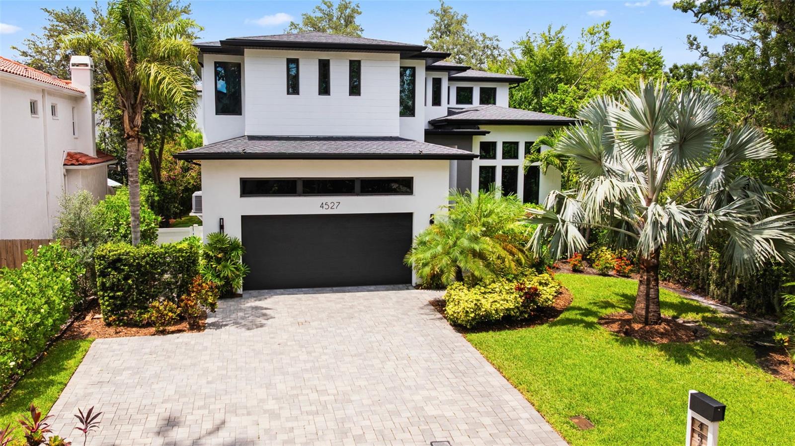 A rare opportunity to own a state of the art custom home where high design meets peace-of-mind construction. Built in 2020 to exceed hurricane standards and elevated above flood levels (with no flood history), this 4-bedroom, 3-bathroom residence offers over 3,200 sq ft of luxurious living in a vibrant, walkable Beach Park neighborhood — just steps to coffee shops, groceries, restaurants, parks, and more. From the solid block construction, resort-style saltwater pool, 4-person full-spectrum infrared SAUNA, every detail was well thought out with no expenses spared.
From the moment you enter, you’re greeted by soaring 20+ ft ceilings in the living room and 14 ft ceilings in the dining area, creating a dramatic yet inviting ambiance. The chef’s kitchen features premium Wolf, Jenn-Air, and Bosch appliances, and a leather finished Dolomite stone waterfall island and full backsplash. Complemented with Restoration Hardware light fixtures and pendants for an upscale modern aesthetic.
The upstairs primary suite is a private retreat, complete with a spa-inspired bathroom, oversized walk-in closet with custom closet system, and a peaceful, elevated view of your backyard oasis. Two additional bedrooms share a well-appointed Jack-and-Jill bath, The downstairs guest suite is ideal for visitors or multi-generational living, with a full adjacent bath and direct access to the pool and outdoor spaces.
Wellness and relaxation are built in — literally — with a private 4-person infrared sauna, perfect for unwinding in your own home sanctuary.
Step outside to your own resort-style backyard with almost 1000 sqft of covered outdoor space, an outdoor kitchen, decorative lighting, and custom railings. The fully fenced yard features a saltwater pool, professional landscaping, and custom lighting, all set on low-maintenance artificial turf — complete with a 3-hole putting green, all beautifully lit with professionally installed outdoor lighting.
For the hobbyist, the garage is a dream: 16-foot ceilings, epoxy flooring, cabinetry and shelving provide function, style, and tons of storage and comfort. The split system A/C keeps the cars cool month after month from the Florida heat.
Additional luxury features of this home include a whole-home water filtration & softener system as well as a tankless water heater.
This is not your typical home—it’s a chance to own a thoughtfully designed residence that has it all — luxury, safety, location, and lifestyle with no compromises.