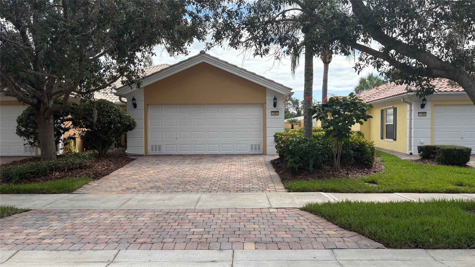 Step into Mediterranean elegance with this beautifully maintained one-story villa, offering spacious living, serene wide water views, and a prime location in the heart of Lake Nona. Featuring two generously sized bedrooms with en-suite baths, a classic tile roof, lush landscaping, and solid concrete walls for enhanced privacy and tranquility, this custom-painted home is packed with upgrades and exudes charm. VillageWalk is celebrated for its world-class amenities and vibrant resort-style atmosphere. Enjoy miles of scenic walking and biking trails, perfect for staying active and connected with nature. The 26,000 sq. ft. Town Center offers something for everyone—clubhouse with ballroom, library, and deli, resort-style and lap pools, state-of-the-art fitness center, six clay tennis courts, basketball courts, and more. The HOA fee covers 24-hour guarded gate security, complete lawn care, cable TV, and high-speed internet. Exterior maintenance includes routine roof cleaning, exterior repainting, and full-service landscaping—mowing, edging, blowing, weeding, fertilization, irrigation, and mulching—all managed by the association. Nestled near major highways (417 & 528), Orlando International Airport, and Medical City, including Lake Nona Medical Center, VA Hospital, Nemours Hospital, and UCF School of Medicine. Minutes from the US Tennis Association’s main campus, top-rated A schools, shopping, dining, and entertainment. World-famous attractions like Disney, SeaWorld, and Universal Studios are just a short drive away