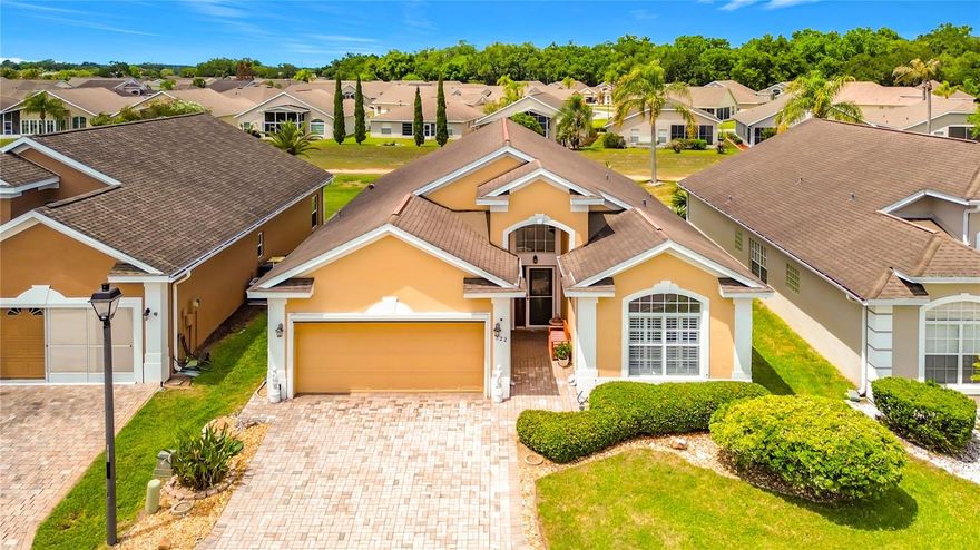 One or more photo(s) has been virtually staged. Welcome to 322 High Vista Dr at Ridgewood Lakes — Where Every Day Feels Like a Retreat  If you've been dreaming of a home where you can truly slow down and enjoy life, this one checks every box. Nestled in the heart of this premier 55+ gated golf community in Davenport, this beautifully maintained 3-bedroom, 2-bath home is a rare find. VIEW VIRTUAL WALK THROUGH. The original owner's pride of ownership is evident from the moment you walk through the door — and it shows in every detail. Soaring vaulted ceilings and a bright, open layout make the combined dining and great room perfect for entertaining. The spacious kitchen features White QUARTZ countertops and backsplash, new Stainless Steel Appliances, Maple Wood cabinets, a pantry, and a built-in desk nook — ideal for morning coffee and recipe browsing. Custom shutters at the breakfast nook let in beautiful natural light, making every morning feel a little more relaxed.  Step out to the enclosed Florida Room/ lanai and enjoy peaceful views of the green space behind the home — your own quiet corner to unwind at the end of the day. The primary suite is your personal sanctuary. The en-suite bath features quartz counters, Dual sinks, a walk-in shower with bench and grab bar, a private water closet, and two closets. The split-bedroom layout provides privacy at the two secondary bedrooms toward the front of the home, giving everyone their own space. Practical touches that make daily life easier: the indoor laundry room with washer, dryer & extra refrigerator, Brand new water heater, new light fixtures and ceiling fans, new stainless steel door handles, New motorized garage screen. There’s also a generator hookup pre-wire on the side of the home for peace of mind. And the community? It's the full package:  Your HOA covers lawn maintenance, Spectrum cable and internet, and access to the clubhouse and pool — so your weekends are yours to enjoy. High Vista's resident-owned clubhouse features a ballroom, fitness center, library, arts and crafts room, and a pub. Outside, you'll find pickleball, tennis, bocce ball, shuffleboard, a heated pool, and a hot tub. Golf cart paths lead straight to the 18-hole White Heron Golf Club and restaurant (for an additional fee).  When you're ready to venture out, you're perfectly positioned — just off I-4 between Orlando and Tampa, minutes from Posner Park shopping and dining, across the street from AdventHealth Hospital and new Publix, and a short drive from Walt Disney World, Universal, LEGOLAND and SeaWorld. - No CDD- **And the seller is offering a $8,000 credit toward new exterior paint**  Bedroom furniture can be included. This is the lifestyle you've been looking for — come see it for yourself!