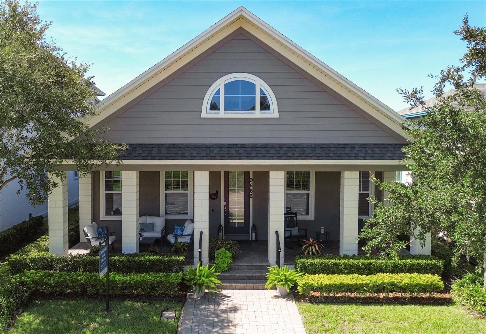 Discover your own private oasis in the sought-after Lake Nona community of Laureate Park. Resort-style living meets everyday comfort. Built in 2017, this beautiful home boasts a freshly painted interior and brand-new A/C system (2024) for year-round comfort. Step inside to find a bright, open floor plan with wood and tile flooring, designer color tones, and inviting spaces from front to back. A formal dining room sits just off the entry, while two front bedrooms provide flexibility for guests or a home office. The gourmet kitchen includes granite countertops, tall cabinetry, stainless steel appliances, a range with hood, walk-in pantry, and a generous island with sink, dishwasher, and ample storage that is perfect for entertaining or casual family meals. The spacious living area centers around a cozy fireplace with charming shiplap wall accents that add warmth and texture. The expansive primary suite provides wood flooring, a stylish barn door leading into a beautifully appointed bathroom with dual vanities, a walk-in shower, and a closet designed for organization. Enjoy the Florida lifestyle outdoors with a welcoming front porch that faces a nature preserve, screened rear lanai, and custom outdoor kitchen surrounded by a fully fenced, landscaped side yard. Additional perks include a detached two-car garage with overhead storage and access to scenic walking/biking trails. Conveniently located near schools, medical centers, shopping, dining, Orlando International Airport, theme parks, and just over an hour to the beach. This is the perfect blend of style, comfort, and location.