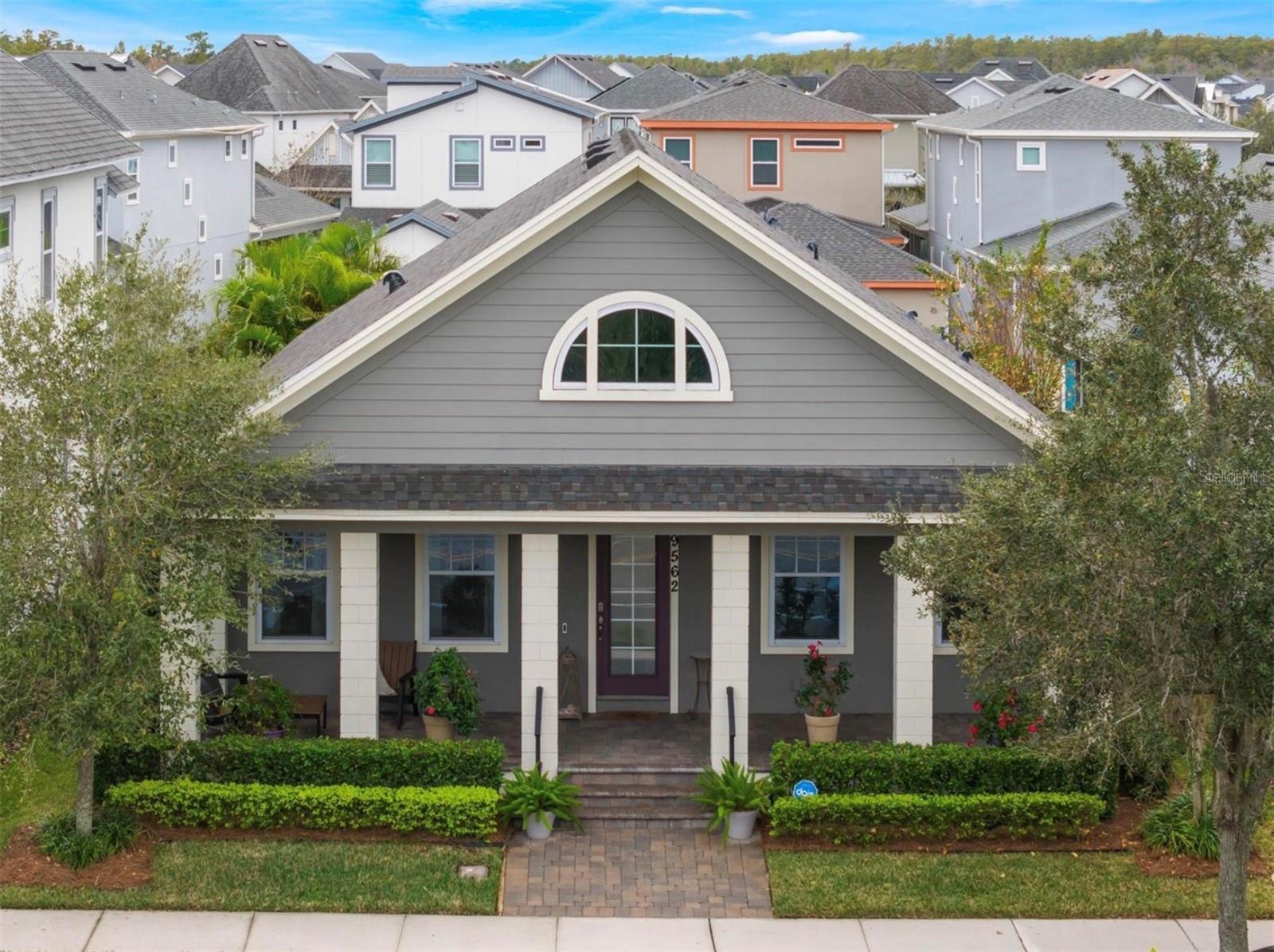 Discover your own private oasis in the sought-after Lake Nona community of Laureate Park. Resort-style living meets everyday comfort. Built in 2017, this beautiful home boasts a freshly painted interior and brand-new A/C system (2024) for year-round comfort. Step inside to find a bright, open floor plan with wood and tile flooring, designer color tones, and inviting spaces from front to back. A formal dining room sits just off the entry, while two front bedrooms provide flexibility for guests or a home office. The gourmet kitchen includes granite countertops, tall cabinetry, stainless steel appliances, a range with hood, walk-in pantry, and a generous island with sink, dishwasher, and ample storage that is perfect for entertaining or casual family meals. The spacious living area centers around a cozy fireplace with charming shiplap wall accents that add warmth and texture. The expansive primary suite provides wood flooring, a stylish barn door leading into a beautifully appointed bathroom with dual vanities, a walk-in shower, and a closet designed for organization. Enjoy the Florida lifestyle outdoors with a welcoming front porch that faces a nature preserve, screened rear lanai, and custom outdoor kitchen surrounded by a fully fenced, landscaped side yard. Additional perks include a detached two-car garage with overhead storage and access to scenic walking/biking trails. Conveniently located near schools, medical centers, shopping, dining, Orlando International Airport, theme parks, and just over an hour to the beach. This is the perfect blend of style, comfort, and location.