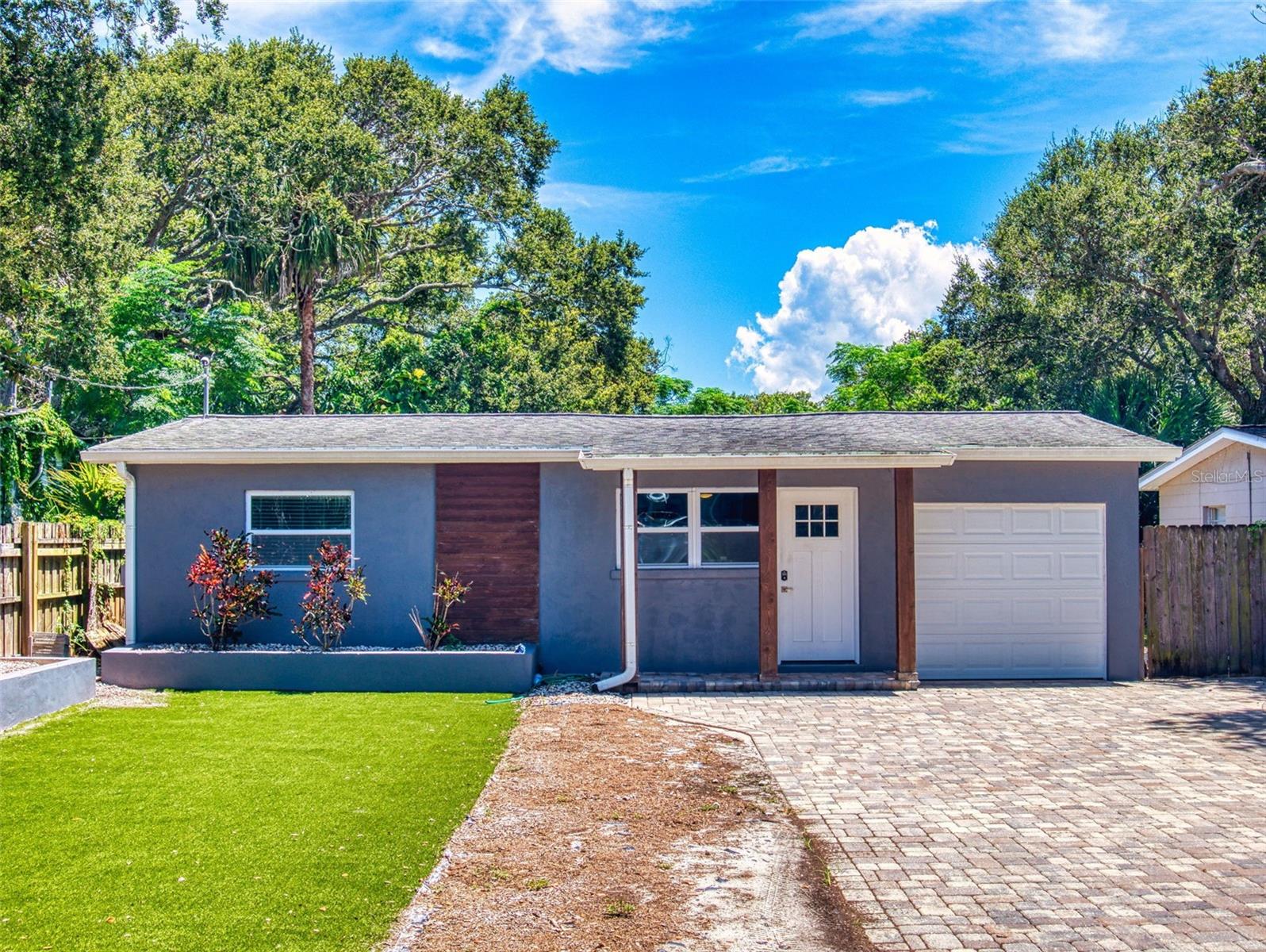 Walking distance to the beach!!! This beachside retreat was Built in 1957 and has all the charm and character of a beach bungalow with modern conveniences. The kitchen was updated with new wooden cabinets, new tile backsplash and appliances. The living room features lots of storage with large built in cabinets and decorative slat wall panels. The split floor plan offers plenty of privacy with two guest bedrooms and a bathroom on the East side of the home including an updated guest bathroom. A brand new master bedroom suite and bathroom were added to the home in 2019 and is located in the back of the house for additional privacy. The large Laundry room was moved inside the home and offers a beautiful glass sliding barn door. The oversized Dining Room was added in 2019 and is currently being used as an exercise room/gym. The Electrical Panel was replaced in 2019 and is located in the Laundry Room for easy access. A noteworthy premium beachside is a 1 car garage. Appliances 2018, Roof 2015, HWH 2018, AC 2022, AC split added 2025. Large backyard area with plenty of space to add a pool and create a tropical oasis. The backyard currently has Astro turf and a putting green. Walk, bike, golf cart to the beach, dining, shopping, hot spots and locally planned events. Dreams come true!!!