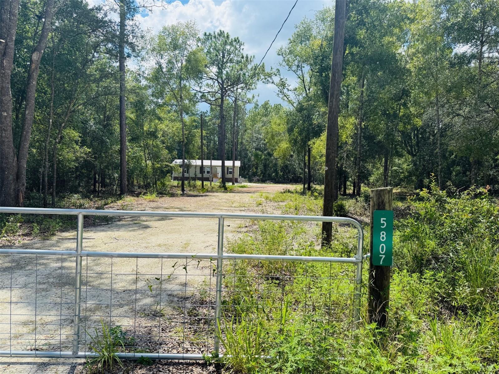CUTE & COUNTRY 3Bed 2Bath on 1(acre) Located near Bell, this lot is secluded and peaceful yet close to the amenities of town. Enjoy Florida wildlife in the tranquility of your own backyard, or make a quick trip to the Suwannee River for boating, kayaking, tubing and more. This Home features an Open Floor Plan with upgrades ~ Metal roof and Metal skirting~ Nice size kitchen with stainless appliances and pantry~ NO carpet ~ Garden tub~ Crown molding~ and more. First American Home Warranty will be provided at closing.