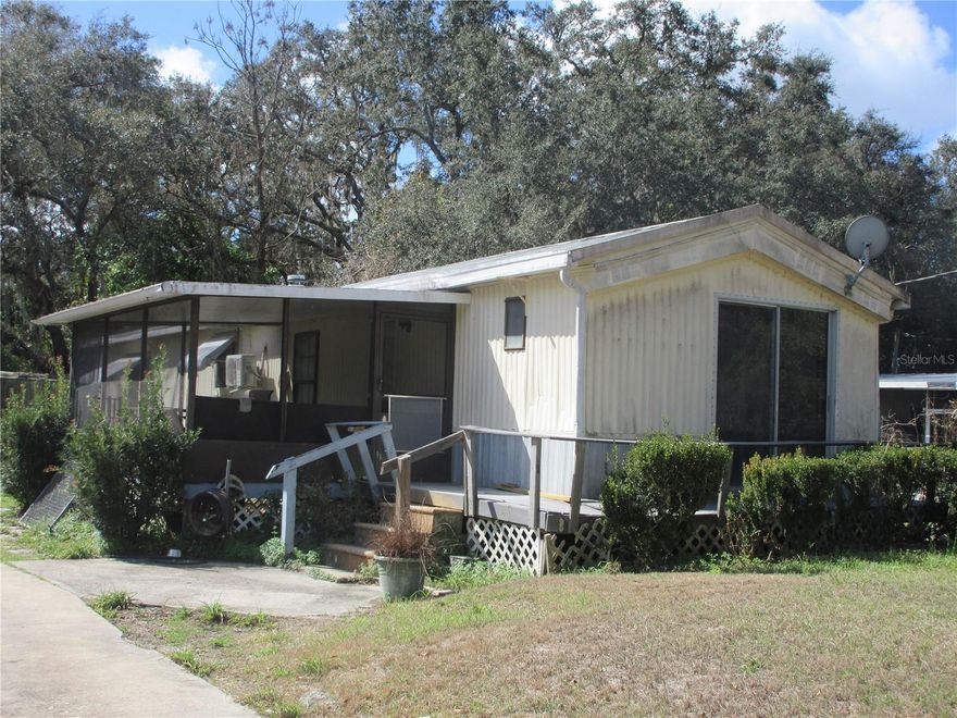Affordable 2/2 Handyman Special! Tired of high rents? Then come see this 80% remodeled 1986 14x60 mobile home with property. No HOA! Inside features a split bedroom floor plan. 2026 upgrades include an electric service breaker box and receptacles, a 2026 Spyder A/C heat duct system (a $10,000 value), 2026 thermostat, 2026 washer/2026 dryer Hookups, 2026 plumbing, 2026 electrical hookups, 2026 rain shower head and plumbing, 2026 shut-off valves, 2026 range hood, 2026 dishwasher, 2026 blinds, 2026 50-gallon water heater, 2026 ceiling fans, 2026 toilet, and 2026 chandelier. Most of the interior was painted in 2026, and the home is 80% remodeled inside. The rest of the remodeling building supplies such as laminate flooring, receptacle covers, paint, and moldings are laying on the guest bedroom and screen room floors, ready to be used. There is also a 2025 mini-split A/C heat unit which serves as a backup to the central A/C heat unit. Most of the plumbing has been replaced, but there is still a remnant of polybutylene grey pipe remaining, but all in good working condition. Appliances are not included. Outside features a breezy 10x16 screen room, a wrap-around (no rot) sun deck, a two-car carport (needs repair), and a 10x16 shed (door needs to be replaced). It all sits on a chain-link fenced .20-acre lot on a paved road. It includes community water, a concrete drive, a walk-in shower, 5 window awnings, and a metal roof. Located in the Ocala National Forest 5 minutes from Winn-Dixie shopping and more. Immediate occupancy. Excellent for a first-time home buyer, rental, winter retreat, or an inexpensive homestead. It needs some TLC but is still a great price at just $69,900! Hurry! Home is located in the Ocala National Forest which affords you almost a half-million acres of forest to roam, 600 lakes, 2 rivers, Juniper Springs, Silver Glen Springs, Salt Springs, swimming, skiing, big bass fishing, boating, camping, hiking, horseback riding, and some of the best ATV riding anywhere. Daytona Beach is just 1 hour away. Let the fun begin! You need it!