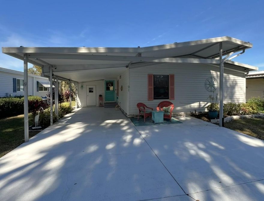 This move-in-ready, 2-bedroom, 2-bathroom manufactured home is located in the desirable 55+ Floral Lakes Community in Bartow, FL. Situated directly on the lakefront, the property comes partially furnished and features a durable metal roof. The spacious kitchen is a highlight, boasting white subway tile backsplashes, a breakfast bar, a closet pantry, a large pass-through window, and ample cabinet and counter space. It is fully equipped with stainless-finish appliances, including a propane range/oven, microwave hood, dishwasher, and refrigerator. Adjacent to the kitchen is a charming dinette area with a built-in hutch, as well as an indoor laundry room with the washer and dryer included.
The bright and airy living room flows seamlessly through fully opening pocket glass doors into the Florida Room, which is equipped with a window A/C unit and showcases stunning waterfront views. In the primary bedroom, you will find a full wall of closet space featuring mirrored doors and built-in shelving that functions as both storage and a hidden entertainment center. The updated en-suite bathroom includes a linen closet and a modern ceramic tile enclosure with a doorless, walk-in shower and glass partition. The second bedroom offers a large closet, while the guest bathroom features a large vanity and a refinished shower/tub combo that brightens the space with classic white finishes.
The exterior of the home is designed for both utility and relaxation, featuring a single-car carport plus golf cart parking and a separate workshop/storage room. A rear concrete patio and a private 9’x24’ floating dock with wood decking on pontoons are ideal for enjoying the lake. Additionally, the seller has installed extra tie-downs and cables at strategic points for wind damage mitigation and peace of mind.
Located in central Florida, between Tampa and Orlando, this golf cart friendly community is near the Bartow Civic Center, Bartow Public Library, and Mary Holland Park. Here you OWN YOUR LAND (no lot rent) and pay low monthly HOA fees. The Floral Lakes community offers access to a stocked pond with community boat ramp and dock. Clubhouse amenities include recreation space, shuffleboard, putting green, and large heated swimming pool. Social clubs, dances, exercise, pot lucks, and MORE! Association approval is required for purchase. Call your Realtor today for more information and to schedule a showing!