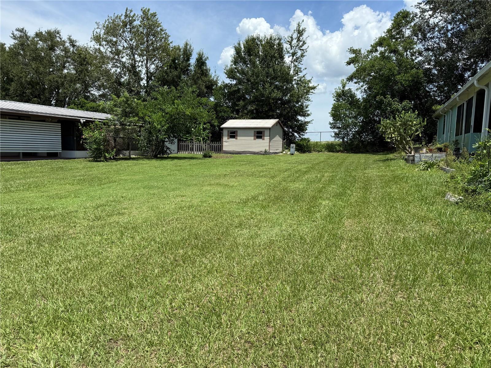 Vacant Lot for Rent! Gives you plenty of room to feel at home, with extra privacy, and currently backs up to an open pasture. This fenced-in backyard also comes with a large storage shed. Dive into a vibrant community life at this charming property! Beyond the comfortable home, you'll discover a wealth of amenities: an inviting heated pool, dedicated RV parking (optional), and high-speed internet and cable for seamless entertainment already installed. Enjoy a friendly competition on the pickleball and shuffleboard courts, hone your swing at the double golf practice tees, or gather around the fire pit for cozy evenings. This community fosters connection with movie nights, card games, potlucks, and coffee hours. Plus, your monthly fees cover water, sewer, trash, and common area maintenance.