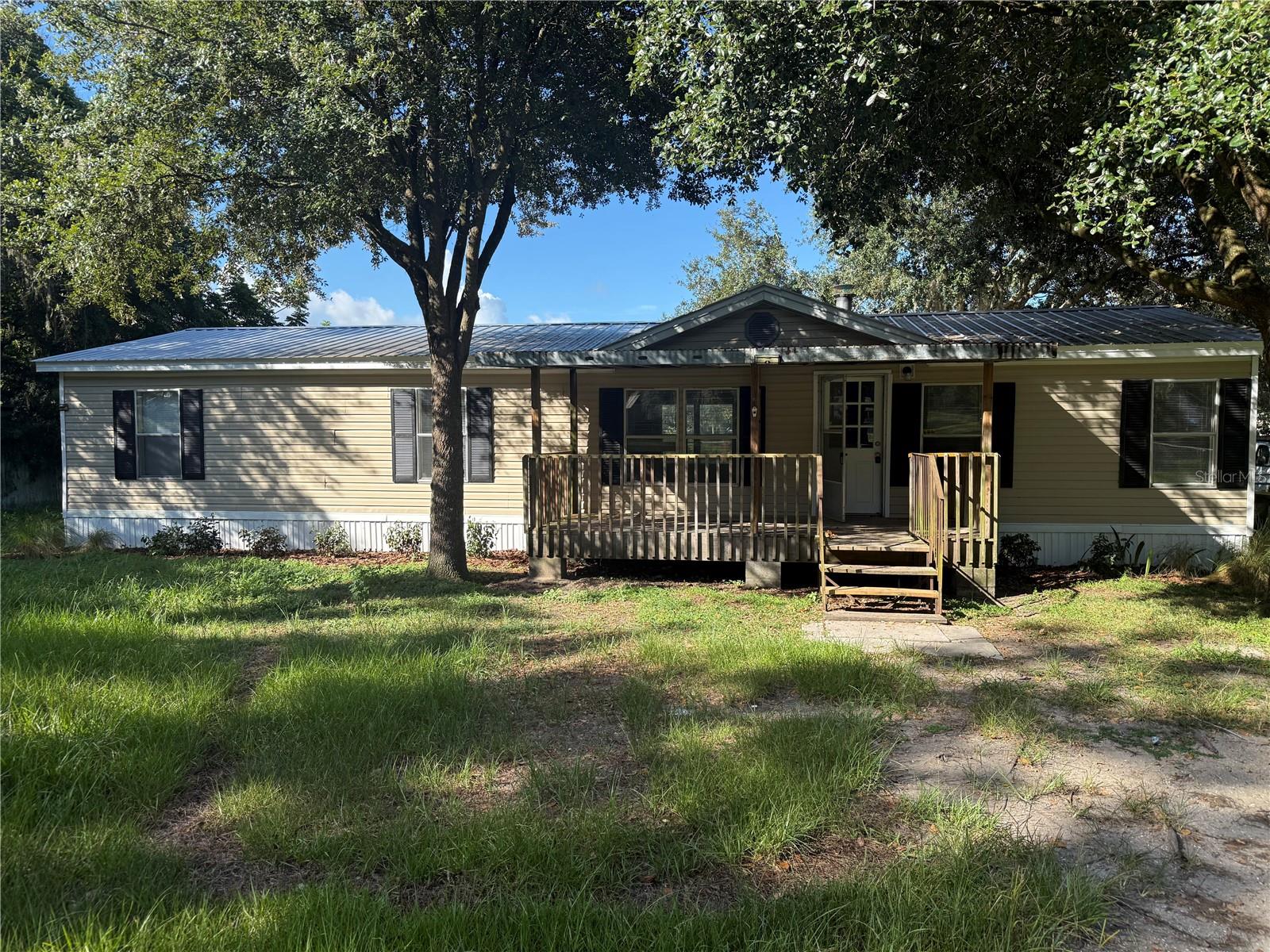 Lovely refreshed 3-bedroom, 2-bath home showcasing a remodeled kitchen with brand-new stainless steel appliances, new cabinets, and granite countertops. The flexible living area is enhanced by a cozy fireplace, perfect for relaxing or entertaining. Both bathrooms have been tastefully upgraded. Situated on over a quarter-acre, the fully fenced yard offers privacy and space to enjoy, while the large rear deck is ideal for outdoor gatherings. This home blends modern updates with comfortable living—don’t miss it!