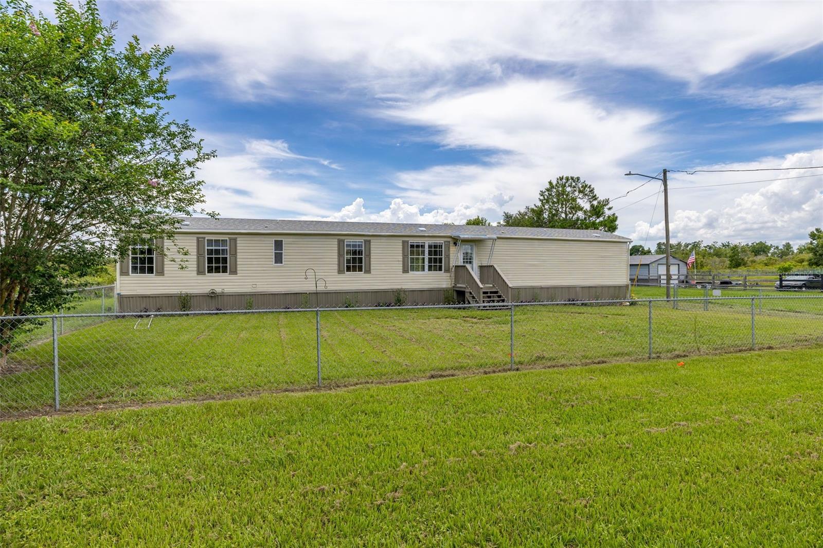 NESTLED on a SPACIOUS HALF-ACRE lot in DAVENPORT, this UPDATED 3-BEDROOM, 2-BATH home offers both COMFORT and PRACTICALITY in a PEACEFUL, NO-HOA setting. The home features a NEW ROOF installed in 2025 and a WELL-MAINTAINED HVAC system, making it MOVE-IN READY. The OPEN LAYOUT is designed to MAXIMIZE the 1,216 SQUARE FEET of interior space, with a SPLIT-BEDROOM floor plan that offers PRIVACY and FLEXIBILITY. The LIVING AREA connects seamlessly to an EAT-IN KITCHEN and a SEPARATE LAUNDRY ROOM, creating a FUNCTIONAL FLOW throughout. Outdoors, the FENCED YARD is ideal for PETS or OUTDOOR ACTIVITIES, and there is about 1/2 of the property that can provide AMPLE Space for storing an RV, BOAT, TRUCK or WORK EQUIPMENT. In addition to the POLE BARN to park your cark. Located in the LOUGHMAN area, the home is ZONED for the DAVENPORT SCHOOL OF THE ARTS and offers EASY ACCESS to MAJOR HIGHWAYS, SHOPPING, and ENTERTAINMENT. CONVENIENT TO I-4. This property is ideal for those seeking a BALANCE between RURAL TRANQUILITY and URBAN CONVENIENCE.