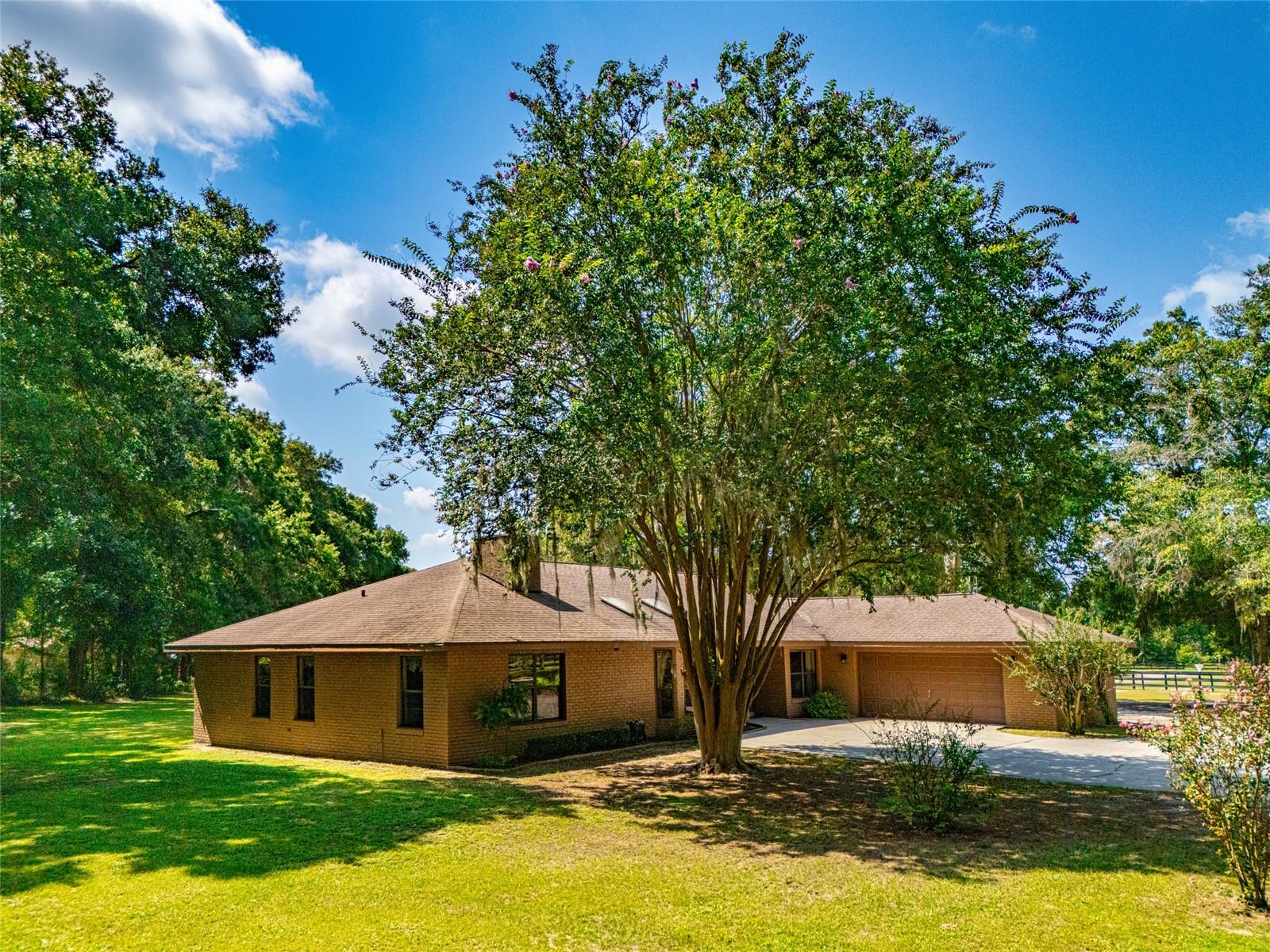 One Owner Home, CLEAN, First time on market. This Custom home was solidly built with Block and a Brick veneer. Featuring a 3 bedroom split plan and 3 Bathrooms (one is in the barn). The living room is spacious and bright with a Beautiful Wood Beamed Vaulted Ceiling , Skylights and a Transom Window. It Features a Wood Burning 2 sided Fireplace built with Stunning River Rock. The Primary Bedroom suite is large (17X21) and has a Fireplace. There is a Formal Dining room suitable for those Holiday Dinners while there is Casual Dining off the kitchen. Relax in the Huge Covered & Screened Lanai overlooking the back of the farm. Surround Sound will keep the party going. The Well Built Concrete Block center aisle barn has 4 (12X12) Stalls with big windows. Keep your Tack in good shape in the Central Air conditioned Tack room, there is also a Feed Room and a Loft for storage. Attached and at the end of the barn is a workshop that could be a fabulous Barn Apt.once renovated. Perfect Airbn. It already has Central Air Conditioning & a Full bath. The majority of the 5.65 Acres is in Pasture while there is a small forest with a walking path as well. This well thought out farm also includes a Detached equipment Garage in addition to the main house garage. This property is very private with its own Gated entry as well the main entrance gate. "Countryside Farms" is an Equine Friendly subdivision located a short 15 minute drive to the World Equestrian Center. This is the last Equine Friendly Gated Community right in town. Literally 5 minutes from Shopping, Dining, Hospitals and all the amenities the city has to offer, YET tucked away behind a Double gated entry. It is typical to see walkers and bike riding with the Homes showing Pride of Ownership . This community offers the Peace and Quiet you are looking for. No Lease restrictions. Would be a perfect Airbnb. Home owners association is healthy . The roads were recently paved. Fees are only $1000 annually. NO Flood Zone on this property.