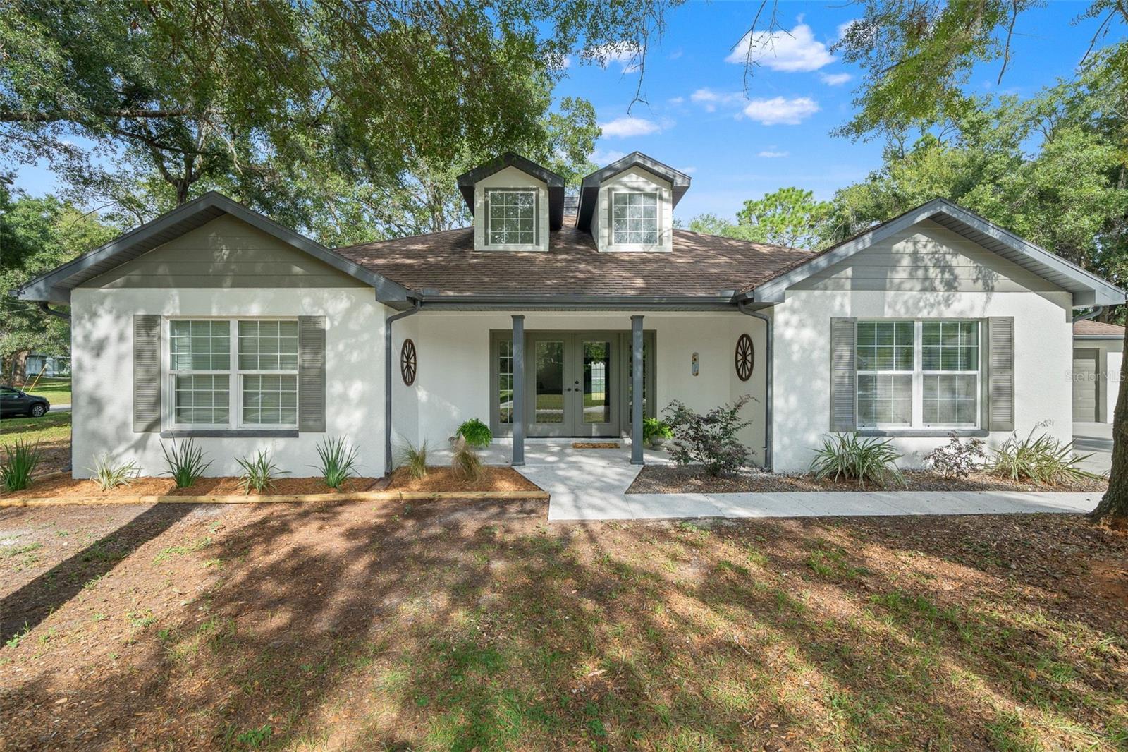 Stunningly Renovated 3-Bedroom, 2-Bathroom Home with 3-Car Garage in Brooksville! Step into this beautifully updated home, nestled on a spacious half acre corner lot in one of the most sought-after areas of Brooksville! From the moment you arrive, you'll be drawn to its charming curb appeal, complemented by fresh paint. Inside, this home has been thoughtfully redesigned with modern finishes throughout. No worries here—it's high and dry, in a NON-flood zone, with NO HOA and NO CDD fees!
As you step inside, the home greets you with an abundance of natural light, pouring in through cathedral ceilings, skylights, and glass French doors that offer stunning views of the expansive backyard. The open floor plan and new luxury vinyl flooring create a seamless flow throughout the living areas, providing an inviting space for both relaxation and entertaining. The spacious yard, perfect for outdoor activities, gardening, or even adding a pool, is accessible directly from the main living areas—blurring the lines between indoor and outdoor living.
With a split-bedroom layout and a versatile flex room that can easily serve as an office or extra living space, this home offers all the room you need. The magazine-worthy kitchen is the heart of the home, featuring a sleek quartz waterfall island, rich chocolate shaker cabinets, a beautiful marble backsplash, and brand-new appliances. Whether you're preparing a quiet meal or hosting friends and family, this kitchen will make every moment feel special.
Both bathrooms have been elegantly updated with marble, and porcelain tile, and custom glass showers. The owner's suite is a luxurious retreat, complete with a spa-like shower featuring his-and-her showerheads—perfect for unwinding after a long day.
Additional updates include a brand-new hot water heater, new HVAC system, and all the modern amenities you need. You'll love the convenience of being just minutes from SR 50/Cortez Blvd, shopping, dining, and entertainment. Plus, you're a short drive from Weeki Wachee Springs, kayaking adventures, and Rogers Park/Pine Island.
With Tampa Airport approx. 45 minutes away and Orlando 1.5 hours away, you're ideally located for both local living and getaway trips. Don't miss out on this gem—schedule your showing today!