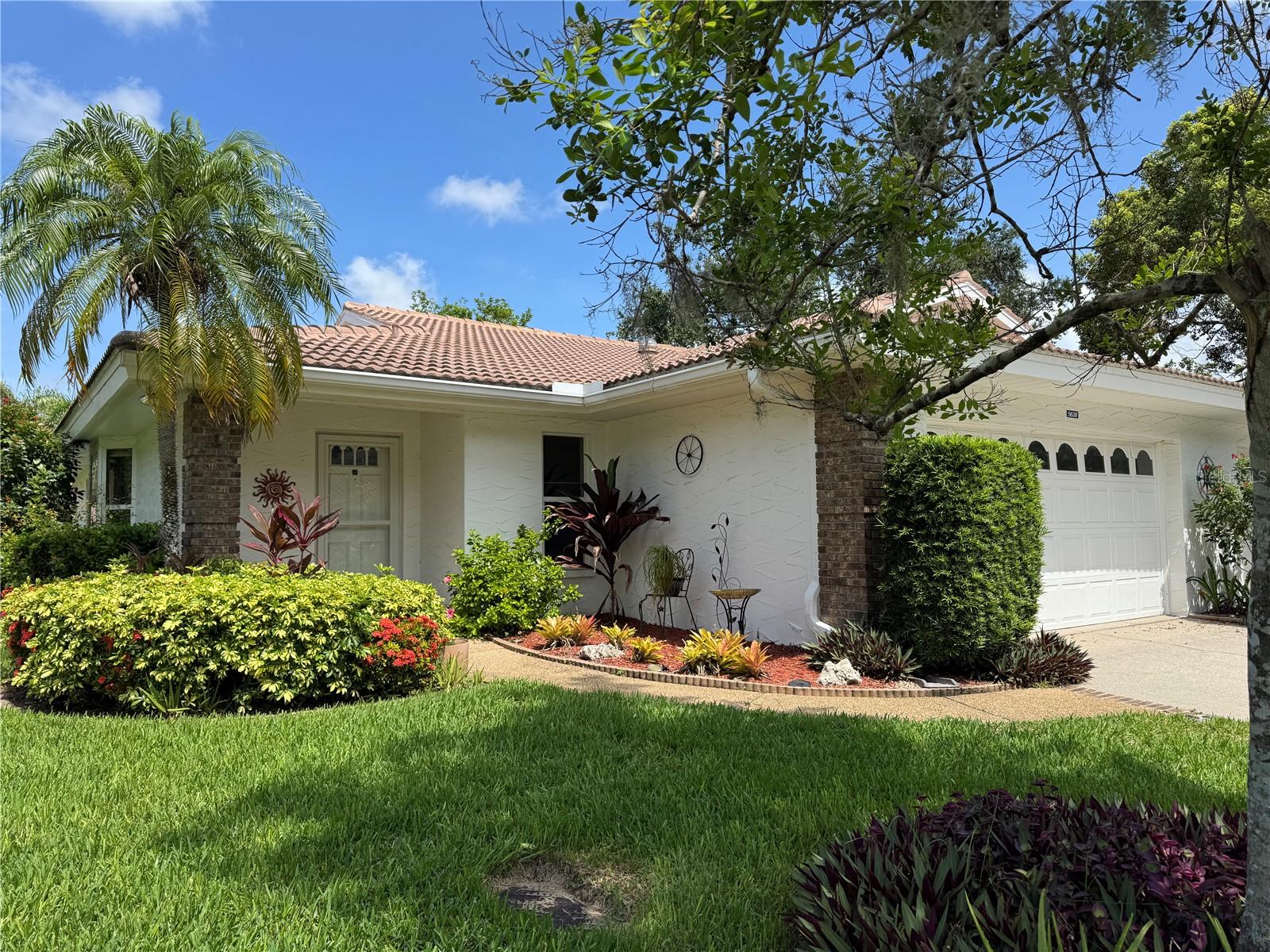 Tucked beneath grand oaks and surrounded by lush, manicured landscaping, this inviting villa feels like a private retreat—but comes with a vibrant social life just steps away. Inside, the open layout flows naturally from the living room to the dining area and into a cheerful kitchen, complete with a spacious pantry, center island, and cozy breakfast nook—perfect for casual bites or coffee with a friend.
The smart split-bedroom floor plan offers privacy for you and your guests. The primary suite features direct access to the enclosed Florida room, so you can greet the day with tranquil views or unwind in total comfort. Your guests will love having their own wing, complete with pocket door privacy and a separate entrance to the Florida room.
Multiple skylights bathe the home with cheerful, natural light. The air-conditioned Florida room offers flexible space for hobbies, reading, entertaining, or simply relaxing in year-round comfort. The garage offers lots of built-in storage to keep all your tools and equipment neat and organized.
Step outside and choose your pace— the tranquil, gated Garden Lakes neighborhood offers something for everyone! Enjoy meeting up with friends and neighbors at the newly renovated clubhouse with full kitchen & dining facility, dance floor, library, meeting rooms, and a calendar chock-full of social events. Stay active and fit with the heated pool, fitness center, pickleball and tennis courts, shuffleboard, or explore the walking trails under shady trees.
Conveniently located near shopping, dining, medical care, and entertainment—with easy access to University Town Center, I-75, and the beautiful Gulf beaches—this home checks all the boxes. Plus, with no CDD fees and low-maintenance living (including lawn care, landscaping, irrigation, cable, and internet included), you can spend less time on chores and more time enjoying life!
This is your chance to embrace Florida living at its best. Schedule your private showing today.