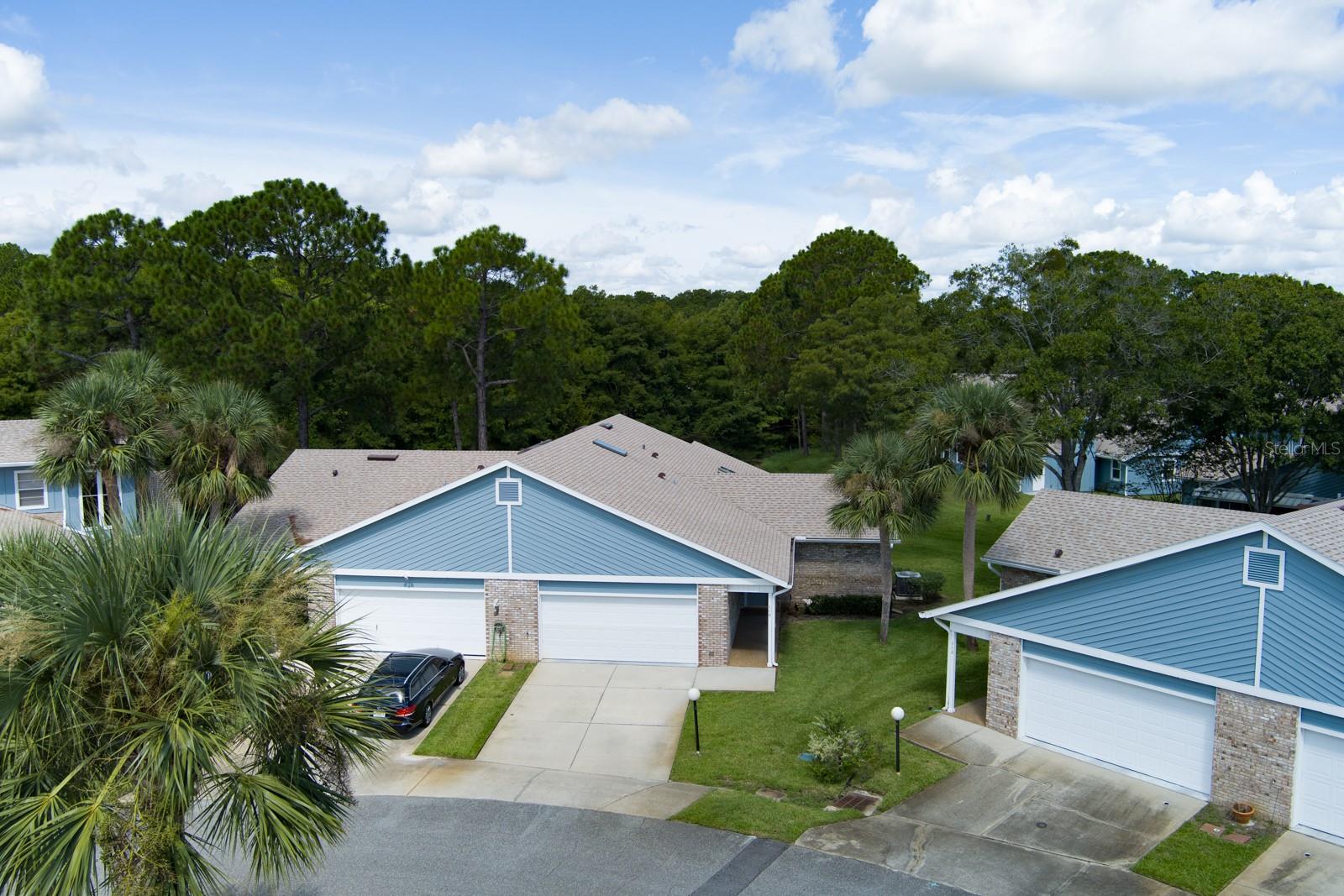 Easy living, zero hassle—perfect for living the Florida Lifestyle. No worries, this is a move-in-ready 2BR/2BA home. Featuring a 2022 roof, A/C 2020, water heater ~2023, beautiful new interior paint, and Hardie board siding 2021. Plantation shutters bring in that bright coastal vibe, while tile throughout creates a clean, modern feel. The primary suite features a nice-sized walk-in closet and en-suite bathroom with a tiled shower and jetted tub. Newer stainless steel appliances with plenty of storage for any chef. The Split floor plan offers privacy and a great open flow from the living/dining room to the screened-in lanai looking out to the pond with a backdrop of mature trees. Bring your golf cart for an easy ride to the clubhouse, fitness center, outdoor pool, tennis & pickleball, and community events. The HOA handles the heavy lifting—exterior & roof maintenance, exterior painting, pressure washing, lawn care, water, cable, garbage, sewer, and exterior homeowners/building insurance, 24-hour security, gated community. Minutes to Embry-Riddle, Daytona State College, Bethune-Cookman, Daytona International Speedway (NASCAR), Tanger Outlets, Daytona Beach Airport, and the beach. Want convenience without the maintenance marathon? Unpack, exhale, and enjoy.