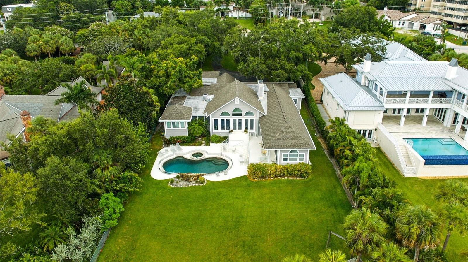 Under contract-accepting backup offers. "Sunset Sereno" A Sanctuary by the Sea. Welcome to 228 Bluff View Drive — A waterfront dream in Belleair Bluffs. Nestled in the coveted, private community of Belleair Bluffs, this nearly one-acre estate offers an unparalleled opportunity to embrace luxury waterfront living. Sitting directly on the Intracoastal Waterway and framed by lush, mature landscaping, this stunning property boasts both privacy and breathtaking water views. Located in a non-evacuation area and an X Flood Zone, the home sits a generous 22 feet above sea level, offering peace of mind even during the most powerful storms. Over the years, this property has been untouched by hurricanes, making it a rare and secure investment in the heart of Pinellas County. With palm trees lining the rear of the estate, your daily views are a picturesque mix of serene waters and tropical foliage with the most breathtaking sunsets, creating the perfect backdrop for a tranquil lifestyle. Just minutes from top-rated beaches, surrounded by top-tier dining and shopping where lifestyle, convenience and charm collide. Whether you’re looking to build your dream home or renovate an existing gem, the possibilities for luxury living are endless.