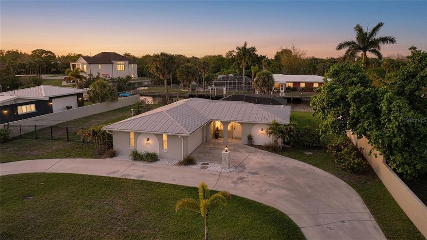 Completely renovated and thoughtfully designed for modern coastal living, this waterfront pool home offers 2 bedrooms plus a versatile flex space that can easily function as a third bedroom, office, or den. The open-concept floor plan creates a seamless flow between the living, dining, and kitchen areas—ideal for both everyday living and entertaining.

The kitchen is well-appointed with shaker-style cabinetry, granite countertops, pendant lighting, a wall oven and microwave, and a separate cooktop, offering both style and functionality with ample storage and workspace. The primary suite serves as a private retreat, featuring sliding glass doors that open directly to the lanai and pool area for effortless indoor-outdoor living. The en-suite bathroom offers a calming, spa-inspired atmosphere designed for relaxation.

Step outside to enjoy a spacious lanai with both covered and open areas, perfect for soaking up the Florida sunshine or hosting gatherings by the pool. Set along a sailboat-access canal with direct access to Charlotte Harbor and no bridges, this property is ideal for boating enthusiasts. Waterfront features include a seawall, private boat dock, and a wrought iron fenced yard, combining functionality with a clean, polished look.

Recent upgrades include all new hurricane-rated windows, sliders, and doors installed in January 2023, along with custom window coverings, adding both style and peace of mind.

Conveniently located near shopping, dining, and the Sunseeker Resort, this home offers the perfect blend of comfort, accessibility, and the Florida coastal lifestyle. Furnishings negotiable, offering added flexibility for buyers seeking a move-in-ready or turnkey option.