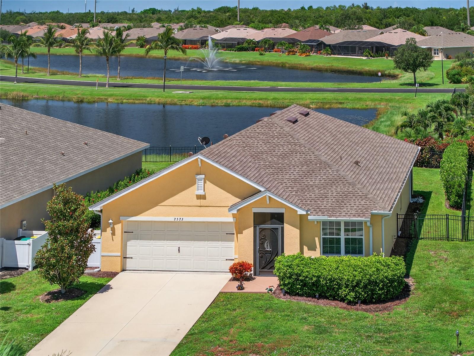 IMMACULATE 3 BEDROOM, 2 BATH, 2-CAR GARAGE LAKE VIEW HOME IN THE GATED COMMUNITY OF WATERFORD ESTATES! Beautifully maintained featuring an open concept and split floor plan that’s ideal for entertaining guests. The spacious kitchen features granite countertops, a large island with bar seating, ample cabinetry, a generous pantry, and upgraded light fixtures throughout. Ceramic tile flooring flows throughout the main living areas, with laminate flooring in bedrooms for easy maintenance. The expansive primary suite boasts a walk-in closet, a private en-suite bath with dual sinks, and an additional closet for added storage. Plenty of privacy for guests with hallway leading to two bedrooms and separate full bath. Step outside to your screened lanai featuring western exposure to enjoy gorgeous sunsets and overlooks fenced backyard ideal for pets to roam. The front entry is also screened, allowing you to open the home front-to-back and enjoy refreshing Florida breezes. Additional features include new roof in 2022, hurricane shutters, irrigation system and nicely landscaped exterior. Waterford Estates is a golf cart-friendly community offering low HOA fees which includes lawn care and access to top-tier amenities such as a clubhouse with full kitchen, fitness center, billiards room, bocce and pickleball courts, and two resort-style pools. Conveniently located just minutes from historic downtown Punta Gorda, residents enjoy easy access to shopping, dining, medical facilities, Fisherman’s Village, parks, walking/biking trails, and Charlotte Harbor for boating and fishing adventures. Don't miss this opportunity! Schedule your private showing today!