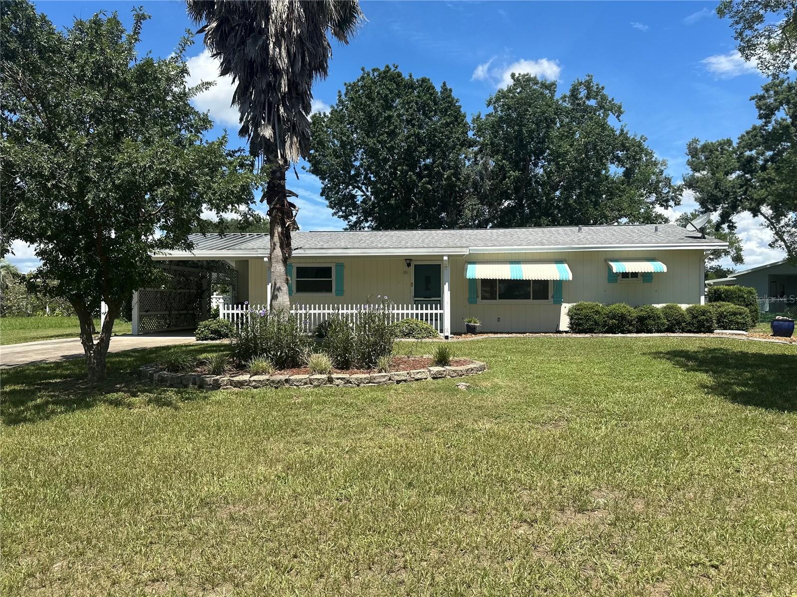 Newer windows, updated kitchen, Roof is a 2018 and the HVAC is a 2017 Carrier model is a must-see home in a fantastic 55+ community. It features a 2-bedroom, 2-bath split bedroom plan, an updated kitchen, and fresh paint throughout. The home boasts a spacious enclosed lanai and a large, fenced yard on a corner lot with flower beds ready for your plants and ideas. Enjoy low amenity fees in an active community offering daily activities, including two pools, billiards, pickleball, shuffleboard.