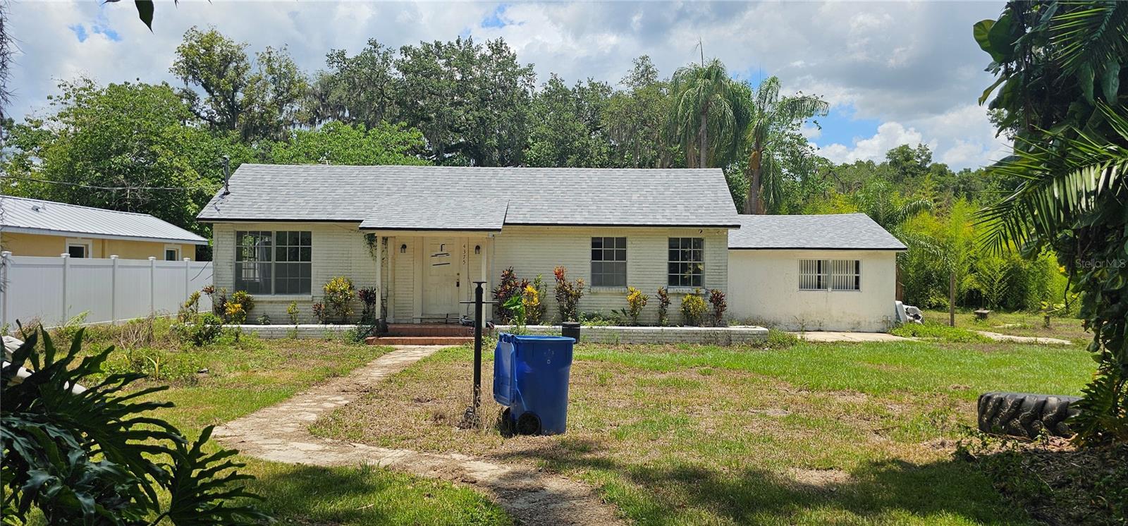 Short Sale. This charming home has the feel of county living but yet still has the city amenities in close by. Remodeled in 2021 (BUT needs some work to bring it back to the condition of the 2021 updated), Four-bedroom POOL Home on a .59 acre and offers an oversized 2 car carport on a concrete slab with electricity. The home has a large living room as you enter with a brick hearth that formerly had a wood stove and gives it the cozy feel with vinyl plank flooring, the living room opens to a formal dining room at the center of the house before stepping down into the kitchen area. The kitchen was fully updated in 2021 with custom shaker style cabinetry, new stainless appliances and plenty of space to add an island for more cabinets and bar seating or to have a dinette. Family room is off the other side of the kitchen and there is a laundry room with a sink that might be a great spot to convert to a full bathroom, plus the 4th bedroom is at that end of the home. The master bedroom has a private bathroom with toilet and sink but the full bath with tub/shower combo is shared. Inground swimming pool in the backyard that offers great possibilities for fun and enjoyment! Super easy access to I-4 for commuting, less than 30 minutes to downtown Tampa and less than an hour to visit Disney World, Universal Studios, Sea World and all the Orlando attractions! Schedule your private viewing today.