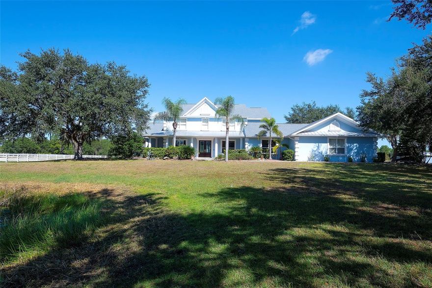 Gated and completely fenced, this elegant traditional home is in the highly sought after neighborhood of Foxwood in Panther Ridge. Its storm ready and perfectly positioned in Zone X, sitting high and dry, with no flood insurance required. Adding to your peace of mind, the house and barn have new roofs in 2025, each with a transferrable warranty. This country estate offers enduring craftmanship. Arrive through the automatic gate to the oak tree lined driveway. The view of pasture and block barn on right and pond on left make for beautiful curbside appeal. Step onto front porch and enter the marble foyer. Once inside you will find an impressive gourmet kitchen with cherry cabinetry, Cambria quarts, a 6 burned DACOR gas range, Sub-Zero refrigerator, Miele dishwasher-ideal for those who love to cook. The kitchen is light and airy with breakfast bar and plenty of room for table to view pool. The first-floor primary suite features a gas fireplace, spa-inspired bath with Mr. Steam shower and brass clawfoot tub, and custom closets with locking cabinetry. The great room has 20-foot ceilings, gas fireplace, marble floors and poplar built-ins open to a screened lanai with an automatic shade for effortless indoor-outdoor living.  Additional rooms on first floor are spacious dining room, office, and private bedroom with ensuite bath. Featured upstairs is a large bonus room with bar connecting to a TREX deck overlooking pool with generous travertine surround. Two additional bedrooms and bathroom complete the second floor. The block barn designed with 4 stalls, individual turnouts, automatic fly system, fans, tack room, feed room, wash racks, and RV outlets. The barn offers infinite flexibility and could be converted into a guest house, workshop, or space for a car collector. Both the home and barn feature Miami-Dade hurricane rated windows and doors. For year-round comfort and security, a 30KW Generac generator and Martin garage doors have been installed.  It is important to note that Panther Ridge offers miles of groomed private trails with bridges, oak hammocks, pine forests. Horseback riding, hiking and biking are allowed with no motorized vehicles to disturb the beauty of Mother Nature. Panther Ridge is a prime location for the Florida country living lifestyle. The serene setting and proximity to hospitals, schools, shopping, sports parks and only 8 miles from I-75.  Bordering on the West side of the community is The Concession Golf Club designed by Jack Nicklaus and Gary Player. Don't miss the opportunity to live and enjoy this home in a unique setting. Places like this are not being built with everything this extraordinary home and property have to offer.