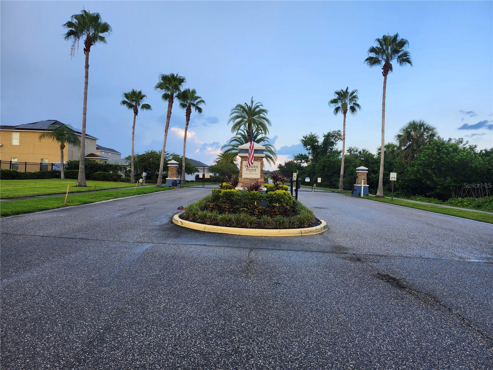 Welcome to your charming three-bedroom, two-bath single-story end unit villa in the gated community of Hawks Point! This meticulously maintained home features a brand-new roof and AC system installed in 2025, ensuring peace of mind. Enjoy extra privacy with a lush wooded backdrop and a coveted split-bedroom, open floor plan complemented by an attached one-car garage.Savor the Florida lifestyle on your screened and covered back patio, which includes retractable sunshades for added comfort. Inside, the spacious living area showcases beautiful hardwood flooring and crown molding, seamlessly connecting to the patio through sliding glass doors.The stylish kitchen is a culinary delight, featuring under-cabinet lighting, granite countertops, and durable ceramic tile flooring. Retreat to the primary bedroom suite, which boasts crown molding, an oversized walk-in closet, and a frosted glass barn door leading to the luxurious primary bath, equipped with ceramic tile floors, a granite dual vanity, and a walk-in glass shower.Two additional guest bedrooms are conveniently located on the opposite side of the home, offering privacy for everyone. This villa is packed with upgrades, including new carpet in all bedrooms, a new garage door opener, a new dryer, a complete set of metal hurricane shutters, and new light fixtures throughout.Residents of Hawks Point enjoy a fantastic amenity center with a dog park, pavilion, community pool, playground, fitness center, and bath facilities, fostering an active and social lifestyle. This property is not in a flood zone and provides easy access to Interstate 75, with a variety of shopping, dining, and entertainment options nearby, including Circles in Apollo Beach and the Cypress Creek Golf Club. this home incudes water, sewer, and garbage as well as all lawn maintenance. Make this delightful villa your new home today!
