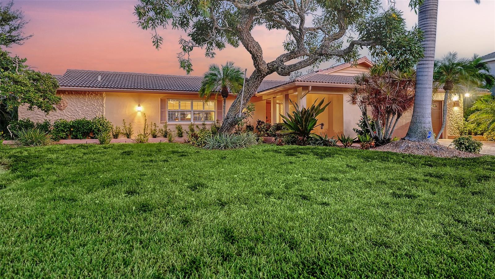 Discover the quintessential Longboat Key lifestyle in this classic masonry beach home located just “3” properties in from Sarasota Bay. Boasting 110 feet of canal frontage, your own private dock, a 7,500 lb. boatlift to complement this classic waterfront treasure it offers direct access for boating, fishing, and kayaking, with frequent visits from playful manatees and dolphins right in your backyard canal.
The thoughtfully designed 2,000+ square foot split floor plan provides exceptional privacy with 3 bedrooms and 2 baths, ensuring guest suites are comfortably separated from the primary living spaces. The “secret” closet delivers a private office space for when you need to work or plan your next boat trip down the ICW. At the heart of the home, an expansive great room and dining area showcases a vintage "Casablanca" bar with seating for four, complete with wine captain, wet bar, and large refreshment cooler—perfect for hosting unforgettable gatherings while enjoying views of the shimmering enclosed pool and water views of your canal beyond.
The chef's kitchen is a culinary masterpiece featuring high-end stainless-steel appliances, built-in ovens, microwave, trash compactor, custom cherrywood cabinetry, separate pantry, and elegant stone countertops with a "chef's prep" island. The layout seamlessly flows into the family room, where glass sliders invite refreshing bay breezes and open to an entertainer's dream: an enclosed lanai, expansive paver patio, and sparkling pool surrounded by multiple seating areas and serene tropical vegetation.
Move-in ready with a new HVAC system and generator, this home has been meticulously maintained with numerous upgrades. Please see the attached “Sellers’ Improvement” feature sheet too many to mention…Offered turnkey furnished, it's perfect as either a primary residence or investment property with substantial seasonal rental income potential. The versatile, expansive lot provides endless possibilities to create your ideal waterfront retreat.
Situated in the exclusive & sought after neighborhood of Country Club Shores, this property offers an enviable lifestyle just steps from world-class amenities. Directly across the street, you'll find championship golf and tennis at the prestigious Resort at Longboat Key Club, along with sugar-sand beaches and fine dining venues that define the resort experience.
The location provides the perfect balance of tranquility and convenience—just minutes to St. Armands Circle, where upscale shopping, eclectic art galleries, and acclaimed restaurants await. Beyond these attractions, Longboat Key offers an array of recreational and cultural experiences, all easily accessible from your doorstep.
As a Country Club Shores resident, you'll enjoy exclusive private beach access for only $100 in annual HOA dues—an exceptional value that enhances the already remarkable lifestyle this address provides.
Whether you're seeking a year-round sanctuary or a seasonal escape with strong investment potential, this is a rare opportunity to embrace the coveted Longboat Key lifestyle. Schedule your private showing today and discover why this barrier island paradise is one of Florida's most treasured destinations. Come live the dream today & just move right in, it’s all here waiting for you !