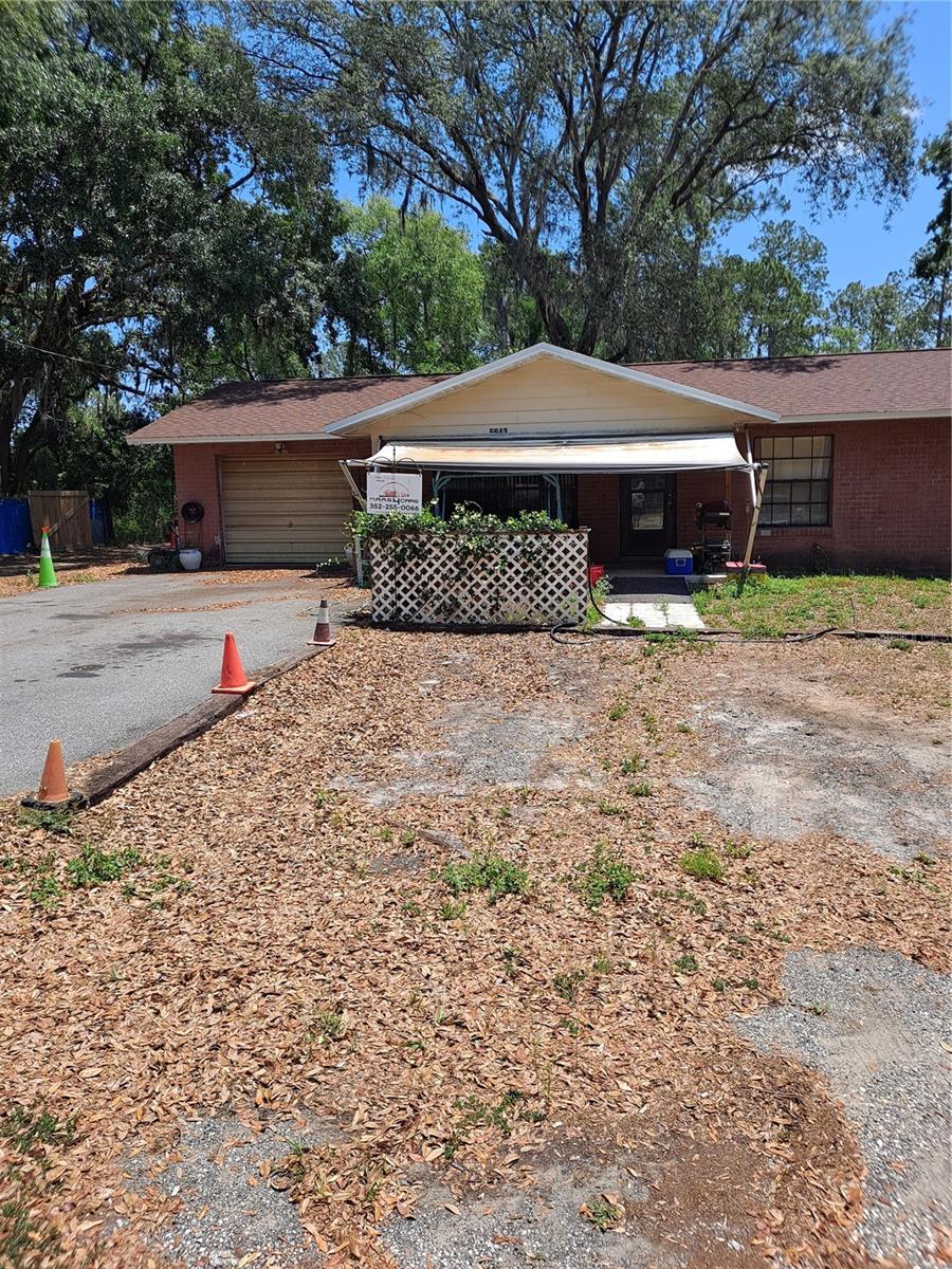 Investors, handyman/handywoman, and mechanics, this 3bed/2bath house is conveniently located just off SR 44. Roof replaced in 2023. It is less than one mile from Brownwood Paddock Square in the heart of The Villages! Access to the Florida Turnpike is less than three miles! Several new homes have been constructed on the block. A 30ft x 30ft building with 10ft x 10ft bays are located in the back yard for boat or auto storage, woodwork, welding, or many more uses. Will be sold AS IS. Current tenant renting month to month and has auto repair shop on premises.