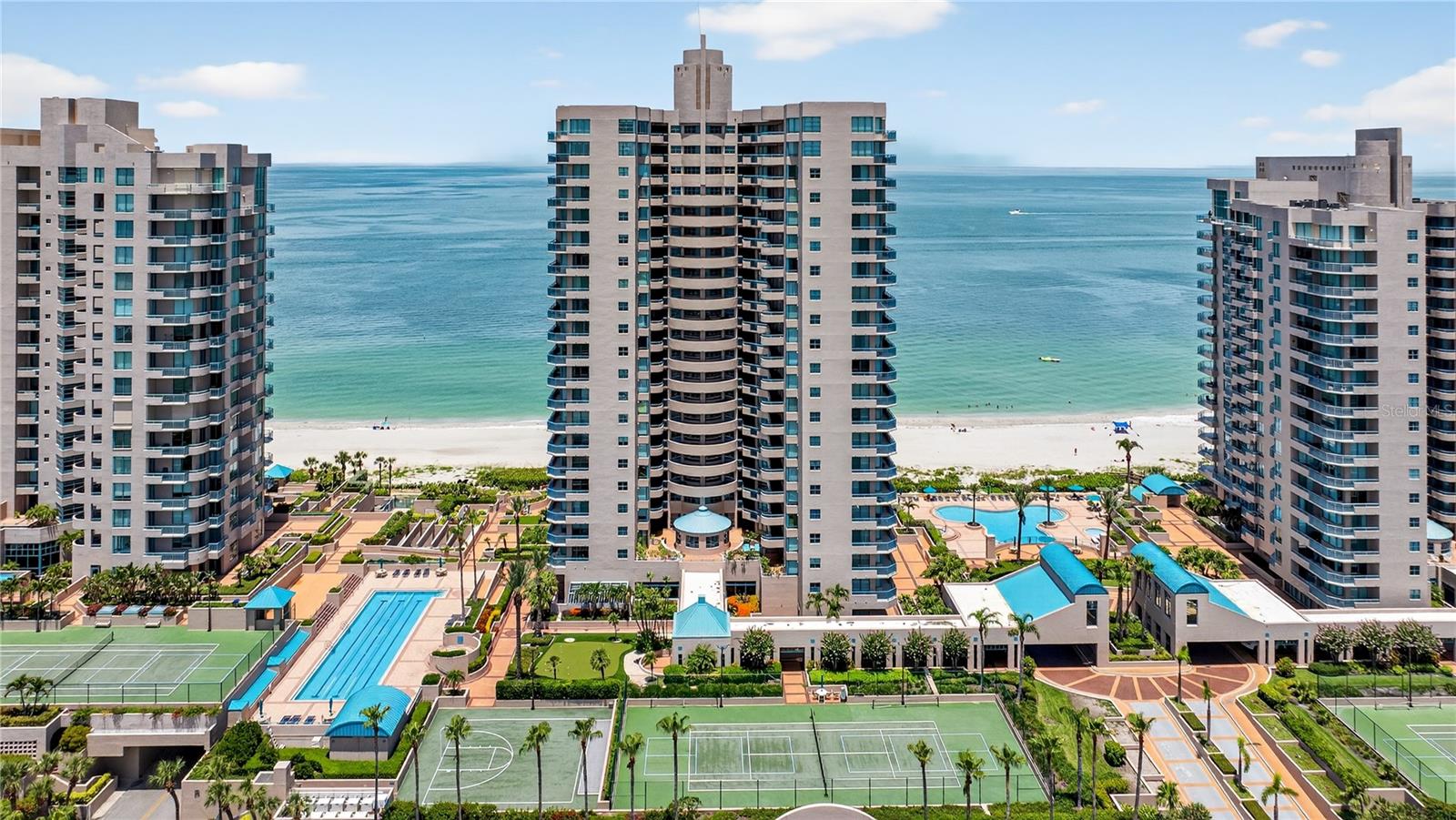 GULF or INTRACOASTAL VIEWS from EVERY ROOM! Breathtaking, 21st floor views of vivid turquoise waters, the glistening crystal shores, natural sea oats and brilliant blue skies are the ideal backdrop for this 2 bedroom, 2 bath condo with nearly 1,600sf. Enter through the double door entry and instantly fall in love with the view. The galley style kitchen can be fully opened for increased functionality. Formal dining area with Gulf and Intracoastal views on one side and a cozy breakfast nook with Intracoastal views on the other side. Hard to choose between, sunrise or sunset? HAVE BOTH from one of TWO balconies. The large wrap-around balcony adds to the relaxing lifestyle with sounds of the surf and the sparkling night lights over Intracoastal. The master suite has a private en-suite bath with endless opportunities to reimagine the space – upgrade to a spacious walk-in shower OR keep the soaking tub with a view! Your guests will appreciate privacy from the split plan and the Intracoastal water view. Ultimar is located on pristine Sand Key Beach. Residents can relax and unwind in the world class amenities including three swimming pools, lap pool, tennis courts, outdoor lounging areas, putting green, basketball, croquet, and fitness center with steam shower and sauna. The club room allows you to host intimate gatherings and is complete with a wet bar, catering kitchen, piano and two full-sized pool tables for your entertainment. Under-building private garage #59, onsite manager and 24-hr guard service add to convenience and security. Only minutes to world-famous Clearwater Beach, water activities, golf courses, fine dining and endless shopping venues. If you’re looking for the best in luxury resort living while escaping the cold this is your next move!