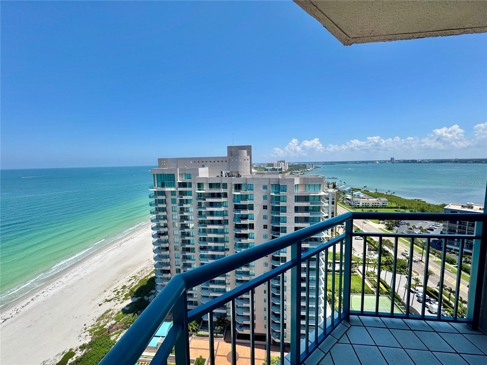 GULF or INTRACOASTAL VIEWS from EVERY ROOM! Live where the Pelicans fly. Rising to one of the highest condos on Sand Key Beach, Enjoy Breathtaking, 21st floor views of vivid turquoise waters, the Gulf shore, natural sea oats and brilliant blue skies. Enter this 2 bedroom, 2 bath condo with nearly 1,600sf and instantly fall in love with the view. The galley style kitchen can be fully opened for an open living concept and even better view! Formal dining area with Gulf and Intracoastal views on one side and a cozy breakfast nook with Intracoastal views on the other side. Hard to choose between, sunrise or sunset? HAVE BOTH from one of TWO balconies. The large wrap-around balcony adds to the relaxing lifestyle with sounds of the surf and the sparkling night lights over Intracoastal. The master suite has a private en-suite bath with endless opportunities to reimagine the space – upgrade to a spacious walk-in shower OR keep the soaking tub with a view! Your guests will appreciate privacy from the split plan and the Intracoastal water view. Ultimar is located on pristine Sand Key Beach. Residents can relax and unwind in the world class amenities including three swimming pools, lap pool, tennis courts, outdoor lounging areas, putting green, basketball, croquet, and fitness center with steam shower and sauna. The club room allows you to host intimate gatherings and is complete with a wet bar, catering kitchen, piano and two full-sized pool tables for your entertainment. Under-building private garage #59, onsite manager and 24-hr guard service add to convenience and security. Only minutes to world-famous Clearwater Beach, water activities, golf courses, fine dining and endless shopping venues. If you’re looking for the best in luxury resort living while escaping the cold this is your next move!