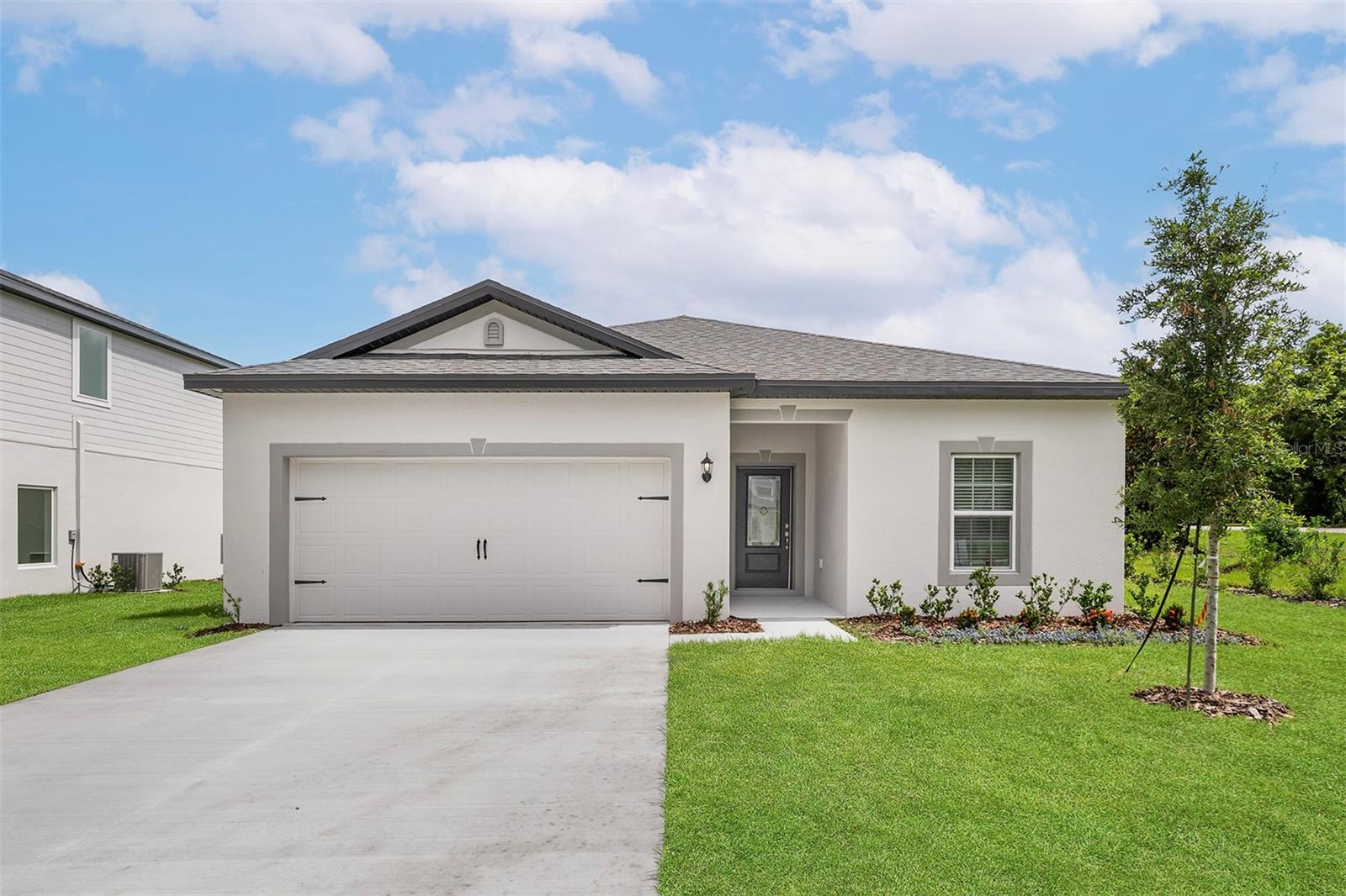 Pre-Construction. To be built. Fall in love with the Amalie model—a beautifully designed 3-bedroom, 2-bathroom home located in the heart of Tula Parc in Astatula, FL! This vibrant, move-in-ready home offers a layout that’s perfect for families, guests, or anyone who loves to entertain in style.
From the moment you step inside, you’ll notice the bright, open living area that invites you to relax and make memories. Two spacious bedrooms are thoughtfully positioned around a full bathroom—an ideal setup for guests or kids. Just off the entry, the oversized two-car garage connects to a convenient laundry room, keeping your home organized and functional.
The sprawling family room is the heart of the home—perfect for movie nights, game days, or simply unwinding after a long day. The kitchen features sleek granite countertops, modern Whirlpool® appliances, and a designated dining space, making meal prep and family dinners a breeze.
Tucked away for privacy, the master retreat offers the comfort you deserve, complete with a sun-filled window, a massive walk-in closet, and a stylish bathroom with an extended vanity and extra shelving for all your essentials.
Outside, enjoy the peaceful setting of Tula Parc, where community charm meets Florida fun! Residents have access to a gazebo, playground, and are just minutes from Little Lake Harris and the Chain of Lakes, perfect for boating, kayaking, and fishing. And with Orlando’s attractions, shopping, and dining just a short drive away, adventure is always within reach.
The Amalie model combines comfort, beauty, and location—schedule your private tour today and experience it for yourself!
