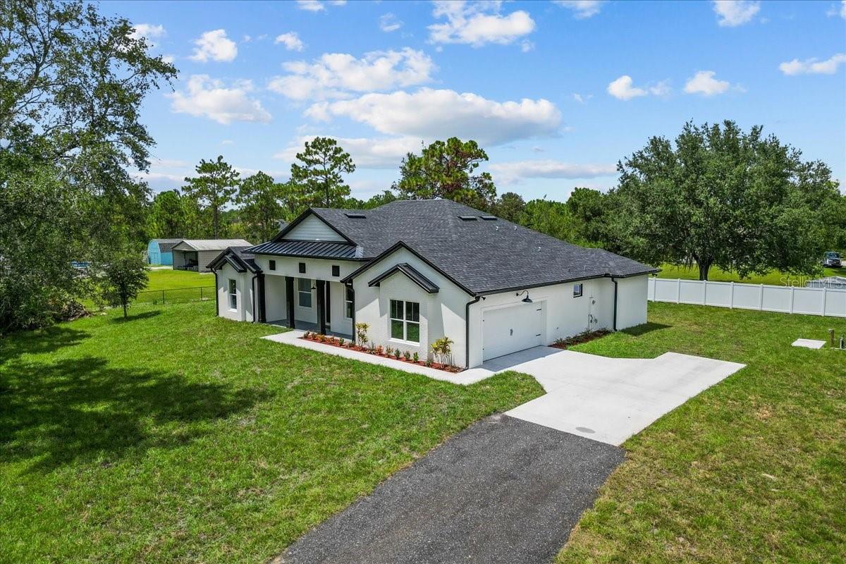 Modern Farmhouse Charm Meets Contemporary Comfort!
This stunning 4-bedroom, 2.5-bath modern farmhouse blends timeless style with today’s most sought-after features. Set on a private, tree-lined acre, the home offers a peaceful retreat while keeping you close to it all..just minutes from Hal Scott Preserve, A-rated schools, and only 30 minutes to the beach or theme parks.
From the moment you arrive, the stone-accented front exterior and metal roof accents set the tone for the home’s upscale yet welcoming feel. Inside, you’ll be greeted by 12’ ceilings, 8’ doors, and double French doors that fill the home with natural light.
The gourmet kitchen is complimented with a large farmhouse sink, quartz countertops, stainless steel appliances, a slide-in range, and a long island with seating. Enjoy casual meals in the large breakfast nook or host gatherings in the spacious living and dining rooms, with a convenient floor outlet in the living room for flexible furniture placement.
The private office offers the perfect work-from-home setup, while the luxurious primary suite boasts a large walk-in shower with bench, dual vanity sinks, generous closet space, and it's own entrance to the lanai.
Step outside to the oversized covered lanai and vinyl-fenced backyard, where you can watch rocket launches in complete privacy. Additional upgrades include epoxied garage floors and full gutters for year-round protection.
If you’ve been dreaming of space, privacy, and a modern farmhouse lifestyle—all in a prime Central Florida location—this is the one to see!