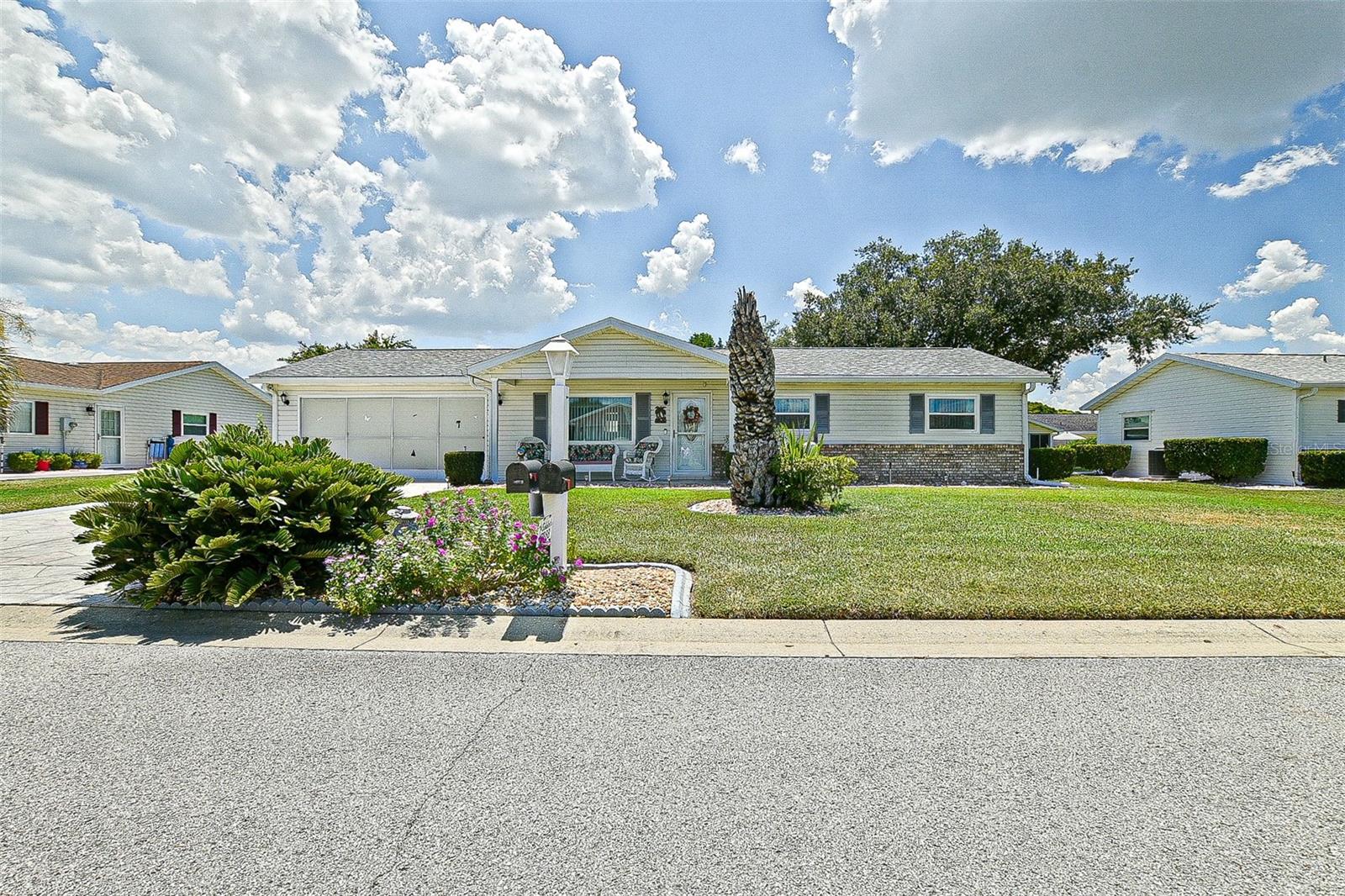 This beautifully updated expanded pecan model in Spruce Creek South offers 1,356 square feet of thoughtfully designed living space, including a spacious 29' x 12' Florida room filled with natural light from glass windows and a skylight. The home features black stainless appliances, newer counters, sinks, and fixtures in both the kitchen and bathrooms, a renovated master shower, comfort-height commodes, and updated lighting. A newer roof was installed in 2021, adding to the value and peace of mind. The Florida room connects gracefully to the dining area through an elegant archway, and opens to an enclosed Lanai through French doors. The extended garage includes a painted floor, abundant cabinetry, and a laundry tub, while outside you'll find a designer driveway and walkway, a privacy screen on the garage door, and easy care landscaping bordered with concrete curbing. Located in a gated golf course senior community near shopping, dining, entertainment, and medical facilities, this home is move-in ready, with some furniture available separately.