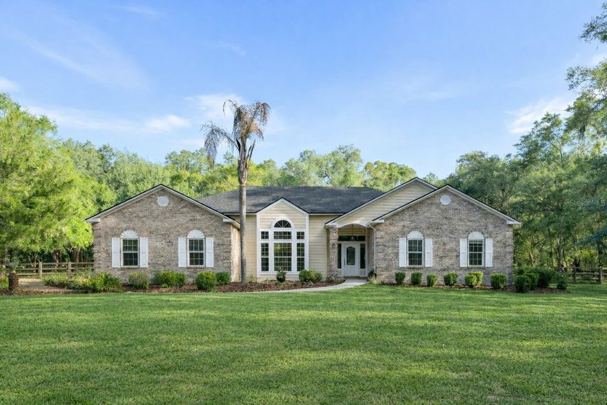 Tucked within a peaceful, quiet cul-de-sac in SW Gainesville’s Thousand Oaks community, this custom-built pool home on acreage offers a refined blend of space, privacy, and everyday convenience.
Set on 2.47 beautifully wooded acres beneath a canopy of mature oaks, this 3-bedroom plus office, 2.5-bath home features a split-bedroom floor plan, generous living spaces, and a flexible office, nursery, or 4th bedroom—ideal for remote work, guests, or a quiet retreat.
With 2,831 sq ft, the home offers separate living, dining, and family rooms with a natural flow for everyday living and entertaining. Soaring ceilings—10 feet and higher—enhance the open, bright, and airy feel. The kitchen includes solid surface countertops, double ovens, an electric cooktop, and abundant cabinetry. Hard-surface flooring runs throughout, with ceramic tile in high-traffic areas, kitchen, and baths, and new luxury vinyl in the family room and bedrooms. Fresh interior paint adds to the move-in-ready appeal.
The spacious primary suite features a large walk-in closet, soaking tub, walk-in shower, and double vanity. A private flex space just off the suite—ideal as a home office, nursery, or 4th bedroom—offers versatility with added privacy.
Outdoor living includes a large screened patio and saltwater pool overlooking the fenced backyard—perfect for your four-legged friends, relaxing or entertaining.
Additional features include a new 2025 25 kW whole-house generator, new roof, Clay Electric utilities, and high-speed AT&T Fiber.
Located in the sought-after Thousand Oaks community, known for custom homes, spacious homesites, and oak-canopied drive, this property is just minutes from the University of Florida, UF Health Shands Hospital, the VA, and Gainesville’s top shopping and dining.
For buyers seeking a private Gainesville acreage home with a pool near UF and Shands, this is a rare opportunity.
One or more pictures have been virtually staged.