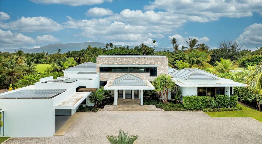 ***UNDER CONTRACT*** No expense spared on this true to form Caribbean contemporary new construction, sitting blissfully at the eastern entrance to the rainforest and within the gates of Bahia Beach Resort. Completed in 2024, 23 Las Estancias stands a testament in true adoration to architectural intention and sophisticated purposeful interior design. Sitting on just over 1/2 acre, each curated detail resonates throughout this 3 bedroom, 3 full bath and 2 partial bathroom single level estate. 20+ Ft entry ceilings pull all of the natural light from the floor to ceiling glass doors, with  broad facing western exposure to the lake, mountains and lush tropical backdrop that only the El Yunque rainforest can afford. Brushed blond wood palettes delicately accent the pinnacle of each room's ceilings, pulling in natural textures to the all concrete structure. Limestone floors add a cool tonality to the juxtaposition of ultra green foliage enveloping the home's elevated exterior facade landscaping. Cascading honed marble countertops highlight this double sized gourmet kitchen, featuring a gratuitous 19x19 footprint, and cornered by 10+ ft glass doors that open fully to the property’s magical oasis. Privacy and purpose reign here, where your outdoor summer kitchen equipped with full gas range, sink and bar moves fluidity towards your zero edge swimming pool, which is adjacent to your outdoor shower and bath, dining, sunning areas and hidden entertaining spaces. Guest suites, each highlighting the exotic nature of living within the resort, feature walk-in closets, ensuite baths and full length picture windows encasing the spaces with fresh sunkissed natural light. The primary wing serves as an homage to refined peace. Double entry doors swing inwards towards the 4 post california king bed, masterfully angled towards the estate’s western outdoor living, where hints of running water from the lake abutting the property’s line, and coconut bearing palms sway off in the distance, to this coast's constant melodic breezes. A basin tub swathed in the greenery exposed by the large bay windows, and indoor/outdoor shower textured in raw stone elements, and an 11' 11” X 13' 11” temperature controlled boudoir and closet round out the home's impeccable design. Warm neutrals kiss every element of design here, where Lutron lighting and shades throughout, a fully off grid solar installation on roof and numerous other refined details, allow the owner the ease of purposeful living. 23 Las Estancias serves as a culmination of vision and passion elegantly aligned in both presence and form. The only of its kind, a true 1 of 1.