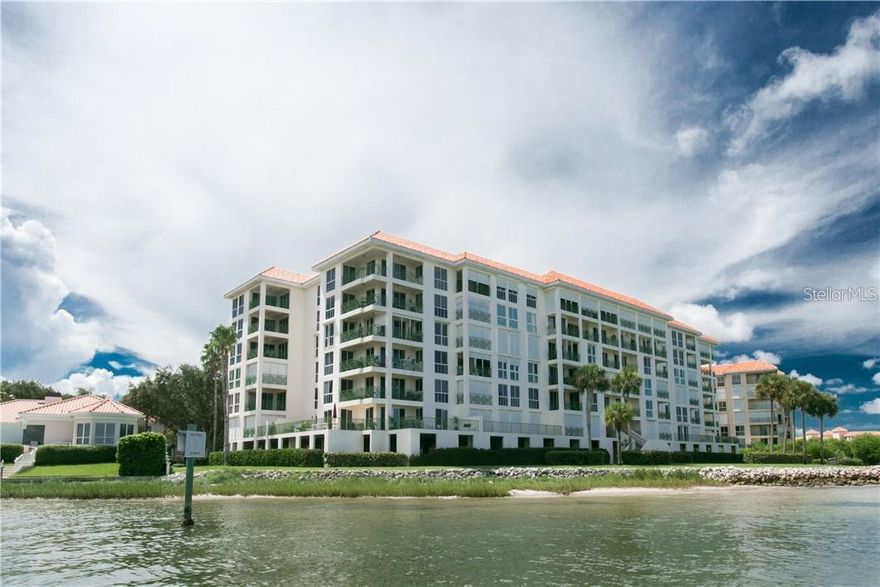 Discover breathtaking waterfront living from this elegant 5th-floor residence overlooking the open waters of Boca Ciega Bay in the sought-after gated community of Dolphin Cay.  Wake each morning to expansive water views and the calming rhythm of the bay from your large, covered veranda, where year-round sunsets, passing boats, and the occasional dolphin or manatee create a constantly changing coastal panorama.
Inside, the open-concept floor plan is designed to maximize both natural light and water views. Floor-to-ceiling windows and 8-foot sliding glass doors bring the outdoors in, filling the living and dining areas with natural light.
The kitchen is perfectly positioned for entertaining, featuring granite countertops, a generous counter bar, and ample cabinetry,
The primary suite is a peaceful waterfront retreat, offering stunning views of Boca Ciega Bay, a custom-designed walk-in closet, and a spa-style bath. The guest suite provides privacy and comfort, complete with a convenient Murphy bed and easy access to the adjacent guest bath and laundry area.  A versatile bonus room offers exceptional flexibility and can serve as a third bedroom, home office, or media room depending on your needs.
Additional features include hurricane shutters, updated windows, a private storage closet, and a reserved in garage parking space.
Located within the guard-gated 88-acre waterfront community of Dolphin Cay, residents enjoy a resort-style lifestyle surrounded by lush tropical landscaping and protected nature areas. Community amenities include:  Private beach and fishing pier, Three heated waterfront pools and spa, Three Har-Tru lighted tennis courts, Kayak launch and waterfront walking trails, Fitness center and clubhouse with billiards and library, two-acre private beach, and On-site management and 24-hour gated entry.
Perfectly positioned just 10 minutes from the vibrant restaurants, museums, marinas, and cultural venues of Downtown St. Petersburg, while also minutes from the Gulf beaches of St. Pete Beach and Pass-a-Grille. Tampa International Airport and St. Pete-Clearwater International Airport are both easily accessible.
An exceptional opportunity to experience peaceful waterfront living in one of St. Petersburg’s most beloved gated coastal communities.