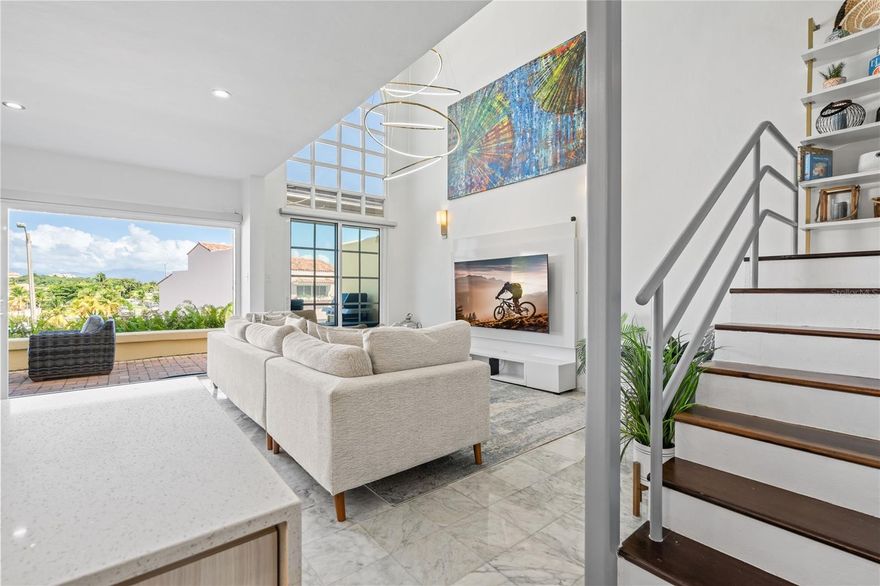 Step into refined coastal elegance with this impeccably remodeled 2,500 sq. ft. residence in Palladio community of Palmas del Mar. This fully furnished, turnkey home offers three spacious bedrooms and 2.5 baths, showcasing a bright open-concept layout enhanced by abundant natural light, high-end modern finishes, and breathtaking marina and ocean views. Designed for both luxury and peace of mind, the property features hurricane-proof windows, solar panels, and Tesla backup batteries for energy efficiency and reliability. Located within an exclusive gated enclave, this exceptional residence seamlessly blends sophistication, comfort, and sustainability—ideal for those seeking an elevated coastal lifestyle in one of Palmas del Mar’s most coveted communities. Offered at $640,000, with monthly maintenance of $395, PHA of $1,300, and hazard insurance is $2109.55.