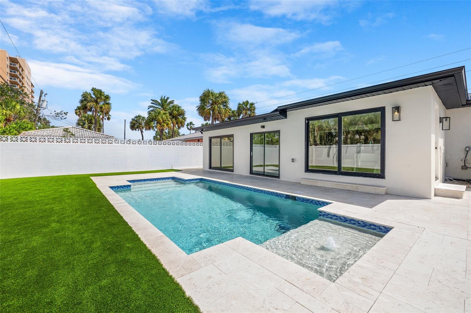 *Luxury Beachside Retreat – 3 BD / 3 BTH – Just One Block from Clearwater Beach* This fully reimagined luxury residence has undergone a top-to-bottom renovation, making it the ultimate turnkey home for use as a primary residence, vacation retreat, or investment property. **No HOA, No CDD** -Zoned for 30-day minimum rentals. Located just steps from the sand and beach access, you'll enjoy the sound of waves and the salty breeze all year round in sunny Clearwater, Florida. Welcome to your dream beach house -- complete with sparkling NEW pool with sunshelf! Step inside to discover an open-concept living area gleaming with natural light, highlighted by sleek finishes and contemporary details. The top-of-the-line kitchen is a true showstopper, featuring stainless steel appliances, quartz countertops, and ample cabinetry—perfect for both casual meals and entertaining. This home has been meticulously updated, boasting a split floor plan for maximum privacy and room for everyone to have their own space. The master suite offers a well appointed ensuite bathroom and double walk-in closets. Two additional spacious bedrooms, each with their own beautifully updated bathrooms, provide plenty of room for family or guests. Outside you’ll find your NEW sparkling pool, low maintenance turf — an ideal space for lounging, entertaining and cooling off after your sunset beach walks. Whether you're taking a refreshing dip or soaking in the sun, this outdoor area will quickly become your favorite retreat. Additional modern amenities include durable metal roof and hurricane impact windows, ensuring comfort and peace of mind for years to come. This home is just a short walk from Clearwater Beach’s pristine shoreline and is close to top-notch restaurants, shops, and exciting water activities. Whether you're seeking a year-round residence or a vacation getaway, this beach house is the perfect place to call home. Don't miss your chance to experience the best of Clearwater living—schedule a tour today!
