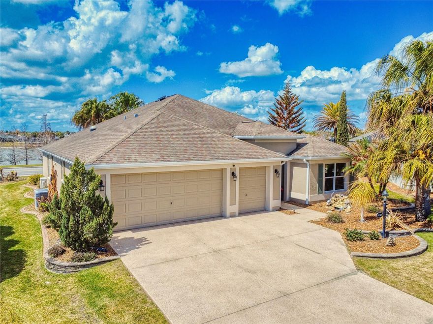 This LOVELY 3/2 IRIS Designer sits on an OVERSIZED lot with PLENTY OF ROOM for a POOL, with a WATER VIEW located in the Village of SANIBEL. This upgraded home has a Florida room with a wet bar, and a patio and pergola outside - a great place to grill with a built-in ALFRESCO grill with piped in propane. This home offers fantastic curb appeal with low maintenance rock beds with stacked stone curbing around the entire home with tropical indigenous palms and flowering plants. Step inside to a spacious foyer with coat closet and pocket door leading to the private guest suite. You'll immediately notice the LUXURY PLANK FLOORING throughout the entire home, with WOOD LOOK PORCELAIN TILE in the Florida room. The kitchen has been thoughtfully modified to include more counter space as well as a wine rack and/or coffee area. The rich expresso cabinetry offers upper and lower pull out drawers in bottom cabinetry, pendant lighting over the breakfast bar, a new composite sink, tile backsplash, STAINLESS appliances with smooth top electric stove, new microwave, and a double door pantry with pull out drawers, and a convenient casual dining nook. The spacious living and dining areas flow seamlessly into the Florida room with no sliding doors to interrupt the space, making it ideal for entertaining. The Florida room is truly a highlight offering WOOD-LOOK PORCELAIN flooring, GRANITE countertops, wet bar with sink and beverage refrigerator, abundant cabinet and counter space, large picture window with a VIEW, mini-split HVAC system, two ceiling fans, and remote controlled exterior shades when needed. From here, step outside to the pergola-covered patio area. The primary suite features a tray ceiling and an EN-SUITE bath with dual sinks and vanity, custom framed mirrors, tiled WALK-IN shower, separate toilet room with pocket door, and a large WALK-IN closet with custom BUILT-INS. The guest suite, located behind a pocket door for privacy, includes two guest bedrooms and a guest bath. One bedroom offers a tray ceiling, the other a vaulted ceiling, and both provide generous closet space. The guest bath features a tub/shower combination and custom framed mirror. The INSIDE LAUNDRY room includes a built-in sink, storage cabinets, washer and dryer (which convey), and a convenient built-in desk nook for home office space. The 2 car plus GOLF CART GARAGE features insulated garage doors and pull-down attic stairs. The nearby BONIFAY and HAVANA Country Clubs offer some of the best golf around. The Colony Cottage Recreation Center and the Colony Shopping Plaza is a short golf cart ride away for fun, shopping, and dining!