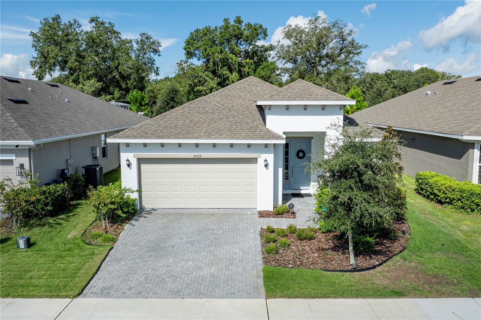 Beautiful pool home now available in the highly sought after Summerbrooke Community located in Mount Dora, FL~ "The Festival City". Assumable VA Loan at 5.25%! Located on a quiet cul-de-sac, 2429 Sirena Lane was built in 2023 and is perfect for a family looking to create lasting memories. This home features four bedrooms, three bathrooms, a two-car garage, and a saltwater pool. The split floor plan includes two primary suites, offering ideal privacy for guests or extended family. Upon entering, you'll be greeted by wood plank tile flooring, abundant natural light, and tall ceilings. The open-concept kitchen, dining, and living room combination immediately draws your eye to the stunning pool and outdoor sitting area—a perfect setting for entertaining friends and family. The kitchen is designed for both entertaining and easy meal prep, boasting an island, quartz countertops, 42" cabinets with ample storage, and a pantry. All appliances are included. From the kitchen, you can overlook the spacious living room, which also features tall ceilings, wood plank tile, a ceiling fan, and a sliding glass door leading to the pool. This door not only provides a beautiful view of the pool and paver deck but also fills the living area with natural light. The main primary bedroom offers a tray ceiling, a ceiling fan, carpeted floors, a large walk-in closet, and an en-suite bathroom with a stand-up shower, glass door, dual sinks with quartz countertops, and a private water closet. The second primary suite includes a ceiling fan, carpeted floors, and an en-suite bathroom with a tiled stand-up shower, glass doors, wood plank tile floors, and quartz countertops—perfect for in-laws or guests. The two additional bedrooms feature carpeted floors, ceiling fans, and built-in closets with easy access to the third guest bathroom. Outside, the 8x17 lanai provides ample covered space next to the beautiful saltwater pool. The screen enclosure keeps out critters and ensures the pool stays sparkling clean while the fenced in backyard offers additional privacy and security. The pool is equipped with both a heater and a chiller, allowing for year-round enjoyment. The home sits just a short distance from the Community Pool, Fitness center and a Park which is all included in the low HOA fee of just $103 per month. The Location of this home is ideal for anyone looking to live in Mount Dora. You are only minutes away from Downtown Mount Dora, Shopping, Restaurants, Medical facilities and Major Highways. Do not wait on a builder home! Call today to Schedule a Private Tour. All information recorded in the MLS is intended to be accurate; however, it should be independently verified by the buyer and their agent. Transferable Termite Bond with Massey Services.