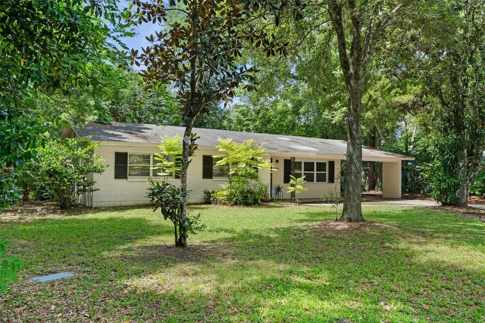Welcome to 3445 NW 8th Avenue, a well-built, move-in ready concrete block home in a location that can’t be beat! Just 1.5 miles from the UF Law School and bikeable to the University of Florida, this 4 bedroom, 2 bathroom home sits on a generous ¼-acre lot and offers room to live, work, and play.
Inside, you’ll find two separate living spaces: a bright living room and a cozy family room. Plus enjoy a spacious kitchen that overlooks the huge fenced backyard. This home is perfect for BBQs, pets, and weekend gatherings. Enjoy plenty of parking in the driveway and a 1-car carport with additional storage (who knows, you may want to enclose the porch in the future!).
Other features include: Electronic keypad entry on the side door, Extra hallway closets, washer and dryer included, and even an attic fan to cool off your attic and roof in the hot summers.
This is a great location. You are 1.5 miles from the UF Law School. You can walk or bike there. You are less than a 5 minute drive to HCA NFL Regional Hospital. You are less than a 10 minute drive to UF Health Shands or Santa Fe College. And if you don’t drive, no problem. Take a 15 minute walk to the bus stop and take the bus to any of these spots! Even Publix, Mi Apa Restaurant, Burrito Famous, PDQ Chicken and other restaurants and shops are less than a mile away. Homes in this price point near UF are not easy to find. Schedule a showing with your favorite realtor today.