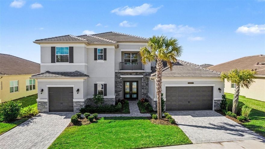 Welcome to luxury living in the highly desirable Winding Ridge community of Wesley Chapel. This stunning Modern/Contemporary Amethyst floor plan by GL Homes offers 4,501 square feet of beautifully designed, fully upgraded living space. The thoughtfully designed floor plan includes 4 bedrooms, 5 full bathrooms, 1 half bath, a private den/office, a huge bonus room/theater, and a 3-car garage. The first floor offers a guest bedroom with its own private bathroom, perfect for visitors or multi-generational living, along with a formal dining room, a wet bar, a powder room, a spacious great room, and a luxurious owner’s suite. Set on a premium pond-view lot, the home features an extended paved backyard, ideal for entertaining or unwinding while enjoying tranquil water views and vibrant sunsets. Inside, a bright, open layout is complemented by soaring ceilings and majestic stairs, creating an impressive first impression. The gourmet kitchen is a chef’s dream, featuring quartz countertops, stainless steel appliances, a gas range, 42” wood cabinetry, and an oversized center island, ideal for both everyday living and entertaining. The owner’s suite serves as a private retreat, featuring his-and-hers walk-in closets and a spa-like bath with a soaking tub, walk-in shower, and a double quartz vanity. Upstairs, you’ll find two additional bedrooms, two full bathrooms, and a massive bonus room/playroom, offering endless flexibility for a home theater, game room, or additional living space. Enjoy resort-style amenities, including pools, fitness facilities, tennis, and pickleball courts. Enjoy resort-style amenities, including pools, fitness facilities, tennis, and pickleball courts. The home also includes a Culligan Water Softener System. When you live at Winding Ridge in Wesley Chapel, you'll enjoy a one-of-a-kind lifestyle with top-tier resort-style amenities, acres of pristine preserves, lakes, and a stunning multimillion-dollar entry to welcome you home every day. Residents can access a magnificent clubhouse and a 5-acre recreation area featuring resort-style pools, fitness facilities, and TENNIS AND PICKLEBALL courts. HOA fees include lawn mowing, landscape maintenance, fertilization, mulching, and exterior pest control. Located conveniently on SR-56, Winding Ridge offers easy access to Wiregrass Mall, Tampa Premium Outlets, USF, Moffitt Cancer Hospital, Advent Health Hospitals, Pasco State College, Center Ice, I-75, and I-275. Just a short drive from downtown Tampa and Tampa International Airport, this location offers an ideal balance of accessibility for professional and recreational pursuits. Don't miss this opportunity. Schedule your showing today and experience the luxurious lifestyle that awaits you!