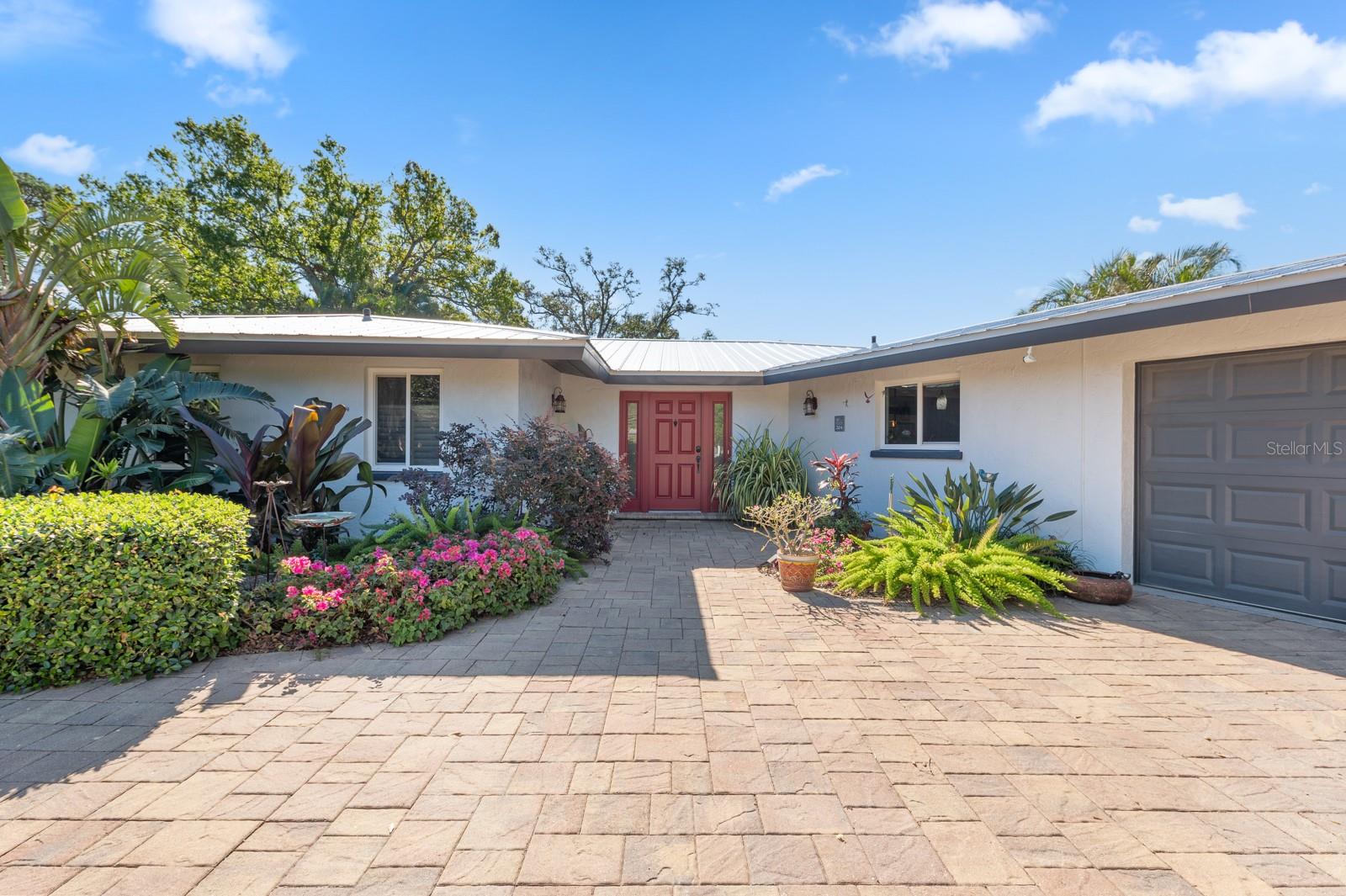 This residence boasts a perfect blend of comfort, style, and functionality, offering an ideal retreat for those seeking the quintessential Florida lifestyle. This three-bedroom plus den/three bath home has designer touches with an open floor plan. Internally, the space sings with an updated kitchen featuring ample counter space, a breakfast bar and perfectly complemented by stainless steel appliances. Every detail has been meticulously curated for your comfort; new metal roof (2020), new hot water heater (2023), detached pool house/outside shower (2019), IMPACT PGT windows and doors THROUGHOUT, and solar pool heater (2021).  The pool and back yard provide a picture-perfect view overlooking the lush tropical landscaping which makes it the perfect space for entertaining. Despite its secluded feel, this oasis remains conveniently close to UTC, downtown Sarasota, the new Mote Marine, and SRQ airport. On daily walks, enjoy the most expansive view of the bay, overlooking Longboat Key.