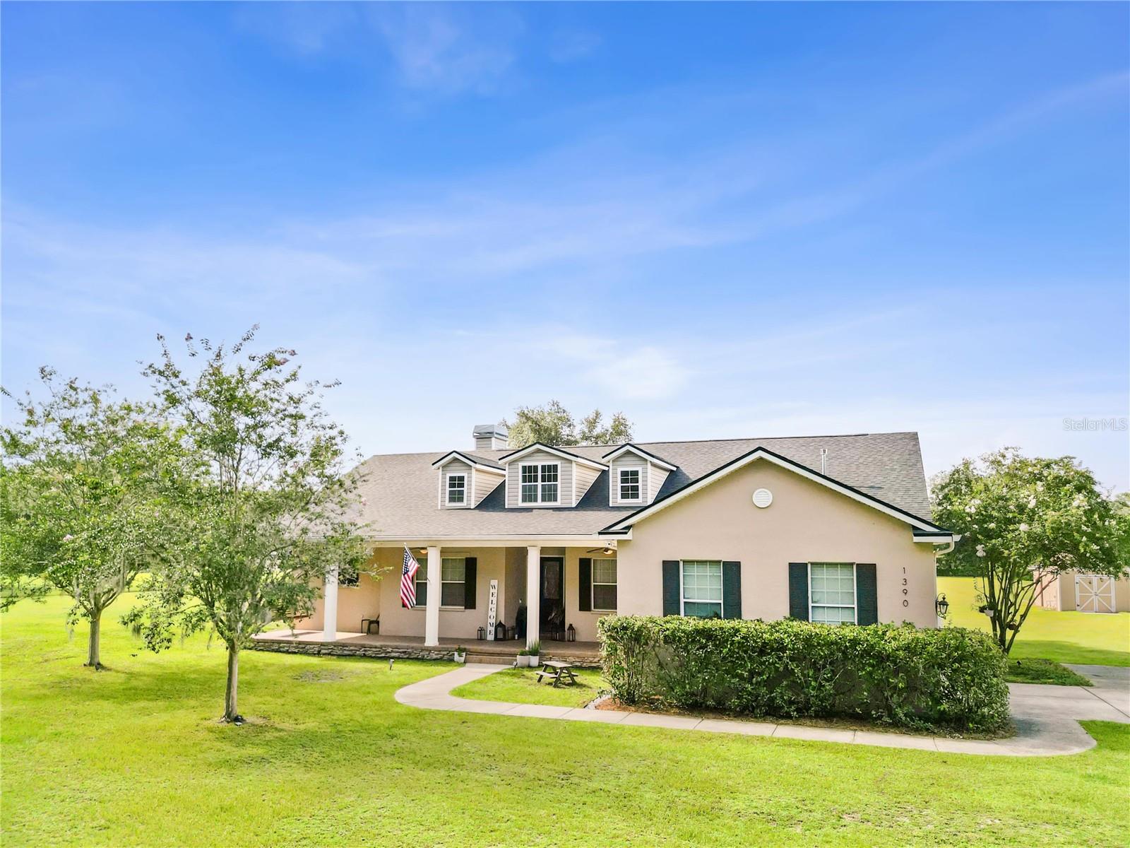 Charming Country Living Just Minutes from Town!
Welcome to this beautiful single-family home nestled on nearly 5 acres in the heart of Sumter County. The perfect blend of privacy, space, and convenience. Located just six minutes from shopping, dining, and top-rated schools, this home offers the ideal setting for family living.
Step inside and fall in love with the spacious split floor plan, featuring over 3,500 sq ft of total space. With 4 bedrooms and 2 bathrooms, including a flexible fourth bedroom perfect for a home office, playroom, or guest room, this layout adapts to your family’s needs. The master suite is privately tucked away, offering peace and privacy. The kitchen boasts brand-new quartz countertops! Kitchen has cooktop stove, and a built-in oven/microwave combo, perfect for preparing meals while staying connected to the rest of the home. The two secondary bedrooms feature brand-new carpet, while the rest of the home is adorned with stunning real bamboo floors and tile in high-traffic areas. Enjoy relaxing on the inviting front porch, already set up with a charming swing and space for rocking chairs, the perfect place for morning coffee or holiday decorating. The back porch is equally spacious and ideal for gatherings, barbecues, or quiet evenings under the stars. This home also features a brand-new roof installed in May 2025, a new septic tank added in 2024, and a new septic pump installed in June 2025. A true wood-burning fireplace adds a cozy touch for the few chilly days we enjoy here in Florida. The two-car garage provides plenty of storage and functionality. With the zoned elementary school just five minutes away, the middle school ten minutes, and the high school only six minutes from your door, this location truly has it all. This is a cozy, well-loved home ready for its next chapter, a perfect place to raise your family and enjoy the charm of country living with the convenience of town just minutes away.