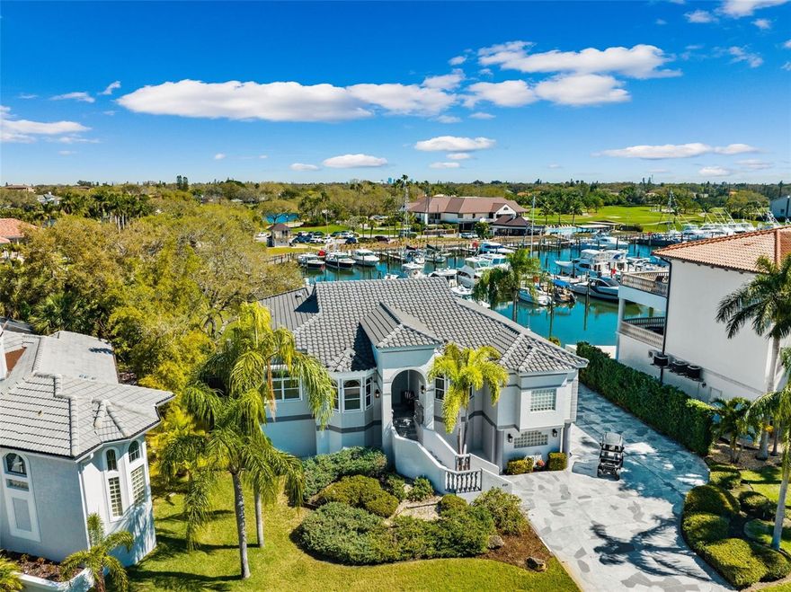 Welcome to this beautiful waterfront residence that perfectly captures the essence of luxury living within the coveted Pasadena Yacht & Country Club. This well-built home is strategically positioned to offer incredible water views of the protected yacht basin, all while resting on an expansive .35-acre lot. The elevated design of this residence ensures a low, transferrable flood insurance premium, and recent upgrades including a new tile roof in 2022, new AC in 2022, and hurricane shutters provide added peace of mind and value to the property. Boasting 4 bedrooms (or 3 + office) and 3 baths, this home features a thoughtfully designed split bedroom plan with high volume ceilings throughout. The separate formal dining room offers versatility, easily adaptable into a second office or flex space to suit your unique needs. The heart of the home is the light and bright kitchen, complete with a large walk-in pantry, white cabinetry, and granite countertops, making it an ideal space for both culinary enthusiasts and entertainers.The spacious family room provides a cozy retreat with fantastic water views, a welcoming fireplace, and sliding doors that lead to the covered outdoor deck, overlooking the inviting pool and spa. This outdoor haven sets the stage for relaxation and entertaining against the backdrop of serene waterfront panoramas.The sizable waterfront primary suite boasts high ceilings, two walk-in closets, and an expansive en-suite primary bath with separate vanities, ample cabinetry, a walk-in shower, a separate tub, and a water closet, creating a luxurious sanctuary within the home.With over 6200 square feet under roof, there is abundant bonus space to fulfill a variety of lifestyle needs, ensuring comfort and flexibility for all. Beyond the home, embrace the resort lifestyle offered by Pasadena Yacht & Country Club, with the unique opportunity to bypass the waitlist and become a member of the only gated, golf course, and waterfront community in the area. Enjoy exclusive amenities and activities, creating a truly unparalleled living experience.