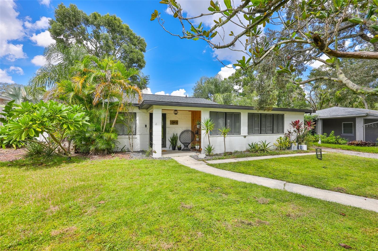 Welcome to this beautifully updated Forrest Hills home, offering 3 bedrooms plus an office/den and 2 bathrooms. This property features numerous updates, including all new interior PLUMBING (2021) and exterior piping to the main sewer (2022). The main ROOF was replaced in 2025 and the flat ROOF in 2020, ensuring peace of mind for years to come. Additional upgrades include a water heater (2024), HVAC and DUCTWORK (2019), and a renovated bathroom (2021). Inside, you'll enjoy the charm of terrazzo and wood-look tile flooring, an indoor laundry room, and a bright, open kitchen with granite countertops, a gas stove, and stainless steel appliances. The home also offers a detached workshop with a carport, complete with plumbing and electric, and a fenced backyard with a paver patio perfect for entertaining and a large propane tank with hookup for a grill. Mature trees have been freshly trimmed to showcase the space and provide a beautiful balance of shade and sunlight. The fenced-in back yard offers a touch of Florida charm with avocado and mango trees, plus a pineapple plant. Freshly painted in 2021, this home is move-in ready and has no HOA. Located in an X Flood zone, so no flood insurance is required. Perfectly situated near Babe Zaharias Golf Course, Busch Gardens, Adventure Island, and a variety of local restaurants, coffee shops, and parks, with an easy commute to downtown Tampa and Tampa International Airport. Call today for your private showing!