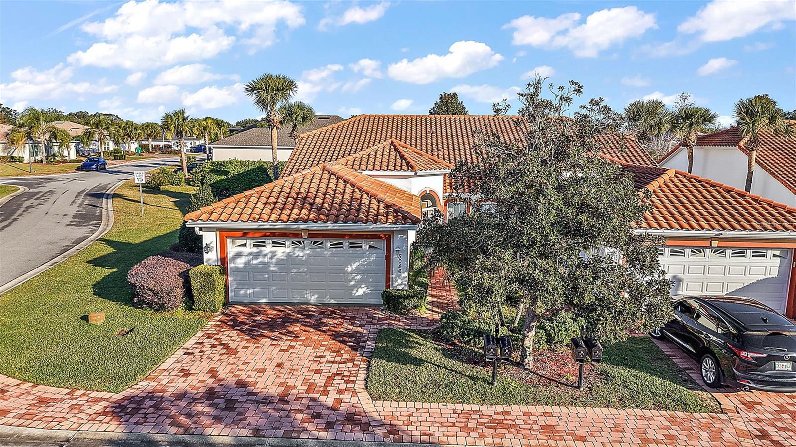 Just minutes by golf cart to The Villages and less than two miles from Lake Sumter Landing, this charming 3/2 concrete block home with a durable TILE roof is nestled in the highly sought-after gated community of Lakeside Landings. Enjoy a low-maintenance lifestyle with HOA-covered lawn care, landscaping, and irrigation. Situated on a spacious CORNER LOT with TOTAL REAR PRIVACY, this property offers a peek-a-boo view of a nearby Lagoon and total rear privacy from both your living room, bedroom, and lanai. As you approach, you will be greeted by an enhanced front yard, featuring lush landscaping, a paver driveway, and a welcoming walkway to your front door. The enclosed front screen porch area offers a cozy spot for your morning coffee, and a retreat to enjoy the beauty of the nearby lush ferns and other year-round plantings. Inside, discover a large bright and airy living room, recently painted, with laminate flooring and vaulted ceilings, featuring unique architectural angles. The dining room, with chandelier, has a convenient pass-through to the kitchen, encouraging light and working ease from kitchen to table. The white kitchen, newly painted, has extensive Corian countertops and white sinks, featuring upgraded and newer appliances in a ‘fingerprint’ resistant and fashionable slate gray. The large window over the sinks invites a pleasant and reflective view of your peaceful surroundings. There is a pantry for food storage as well. The Primary bedroom features a brand-new LUXURY VINYL PLANK flooring, fresh paint, and two large and separate WALK IN CLOSETS, also with Vinyl Plank Flooring. The Primary bath has a GARDEN SOAKING TUB, double sinks with Corian counters, and a tile shower. With two additional bedrooms, one with carpet and another with laminate, are also freshly painted. Each bedroom has its own closet, along with a full tub/shower in the second bath. The white laundry room features newer large KENMORE ELITE top- loading washing machine, and dryer, with cabinetry for storage and a utility sink. Recently installed is a “Comfort Hot Water System,” with or without a timer. This provides instant hot water to any area of the house. The garage door has recently had all metal wheels replaced, and is in good working order, including a keypad outside for easy access. All screens have been recently replaced and there are gutters around entire house. With its beautiful landscaping, corner lot, spacious layout, and thoughtful details throughout, this home offers an unmatched lifestyle in Lakeside Landings. You will love the recently installed comfort hot water system. Don’t miss the opportunity to make this beautiful property your own! Lakeside Landings is conveniently located off of CR 472 (Rainey Trail) between US 301 and Buena Vista Blvd in The Villages. Community amenities include a resort-style pool (one of the largest in the area) and spa, clubhouse, exercise facilities, pickleball, tennis, playground, beach area with access to Lake Miona and more! Lakeside Landings residents will also enjoy close proximity to THE VILLAGES CHARTER SCHOOLS, shopping, restaurants, banks, and The Villages community, as well as Lake Sumter Landing Market Square in The Villages, which offers a variety of dining options, movie theaters, and nightly entertainment 365 days a year. Walmart, Fresh Market, and Publix are only minutes away on CR 466. Don’t miss the opportunity to own this exceptional home in a prime location—schedule your showing today!