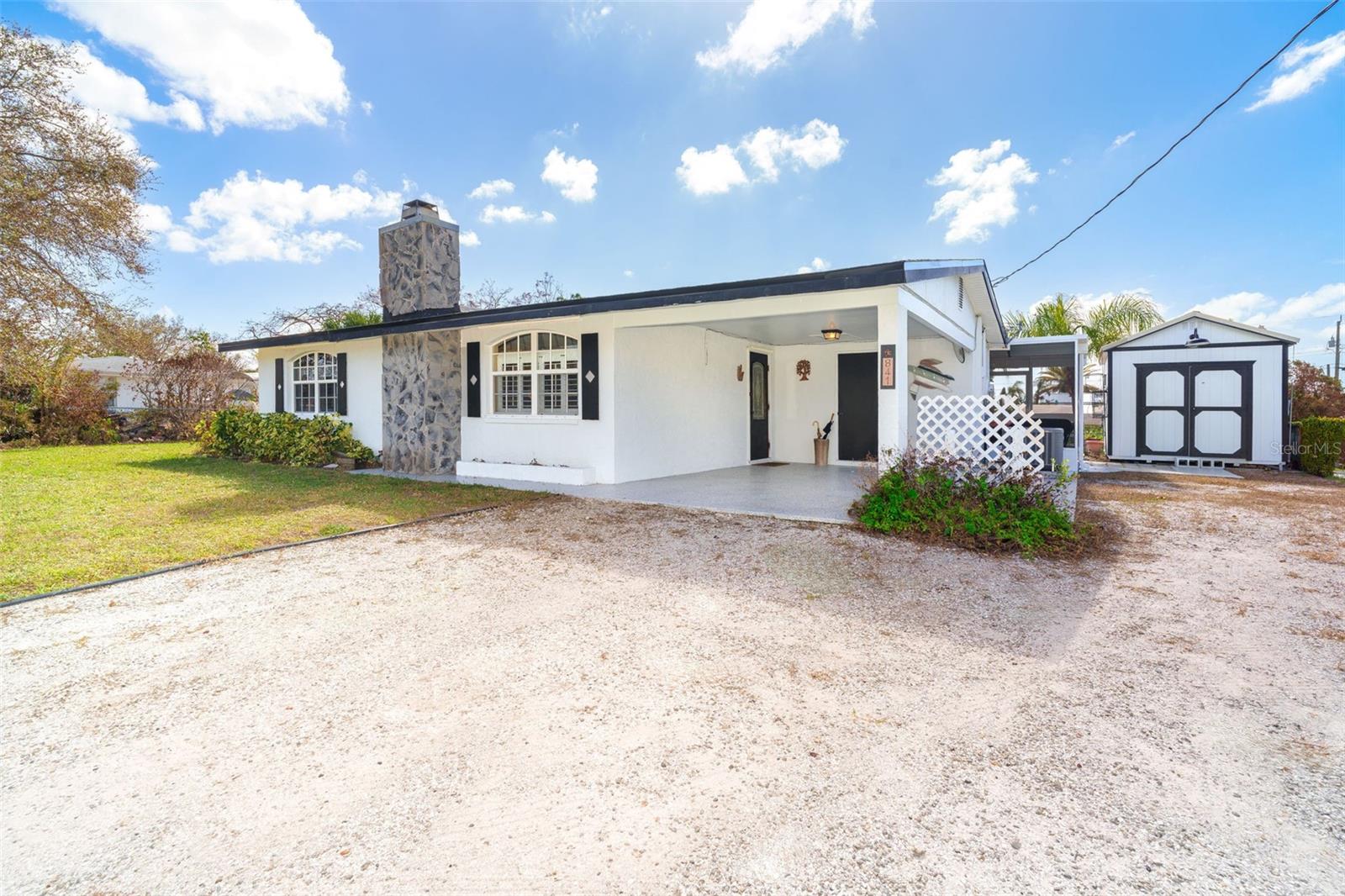 Welcome to your waterfront oasis! This stunning 2-bedroom, 2-bath gem, with a NEW roof and NO storm damage, offers all the charm and functionality of a coastal retreat. With 100 feet of saltwater canal frontage and covered boat lift, you'll love the tranquil views and effortless access to the water. Step inside through the beautiful leaded glass door to find an updated, open space highlighted by elegant porcelain tile floors. Newer windows, equipped with hurricane shutters, fill the living areas with natural light while providing safety and peace of mind. At the heart of the living room, a wood-burning fireplace with an electric insert adds warmth and ambiance, complemented by custom window treatments and plantation shutters for a refined touch. The kitchen is a chef's delight, with a tasteful tile backsplash, beadboard ceiling, and ample cabinet space, all enhanced by a large window over the sink that offers a captivating view of the water. The second bedroom features a versatile Murphy bed for flexibility, and both bedrooms include stylish ceiling fans and light fixtures. Outside, your personal oasis awaits. The screened lanai lets you enjoy the gentle Florida breezes, while the covered patio is perfect for gatherings. The composite dock, complete with water, electric, and a 20,000 lbs boat lift, is a dream for boaters. A large shed provides convenient extra storage.
Ideally located near Manasota Key and Boca Grande beaches, this home also offers easy access to shopping, dining, world-class fishing, and several golf courses. Boating enthusiasts will enjoy quick trips to the Intracoastal Waterway and the Gulf. Sold fully furnished, this home is truly move-in ready, just pack your bag! Don't miss your chance to own this slice of paradise; schedule a showing today and make coastal living a reality!