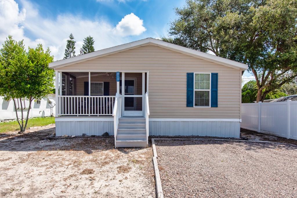 Affordable comfort in a prime location! This well-kept 2-bedroom, 2-bath manufactured home offers comfort, convenience, and plenty of space for everyday living. Built in 2016 on a lot hand-selected by the original owner, the home features 976 sq. ft. with a thoughtful split floor plan. A screened front porch with a ceiling fan invites you to relax, while vinyl flooring flows throughout for a clean, easy-care look. The kitchen is fitted with timeless white appliances and ample storage, making meal prep simple and enjoyable. Smart updates include a 2023 AC system and the original 2016 shingle roof. The entire base of the home is wrapped in protective wire, adding long-lasting durability. Parking is never an issue here—with plenty of space on the property and a low HOA fee to keep monthly costs in check. For those with an adventurous side, the community also offers a designated area for RV, boat, or trailer storage at a yearly rate of $300 to park in the small lot or $500 a year for the larger lot —ideal for those who love to explore. Best of all, the home is in Flood Zone X, giving you added peace of mind. Conveniently located near US-19 and just steps from the Pinellas Trail, you’ll enjoy quick access to shopping, dining, and the outdoor Florida lifestyle.