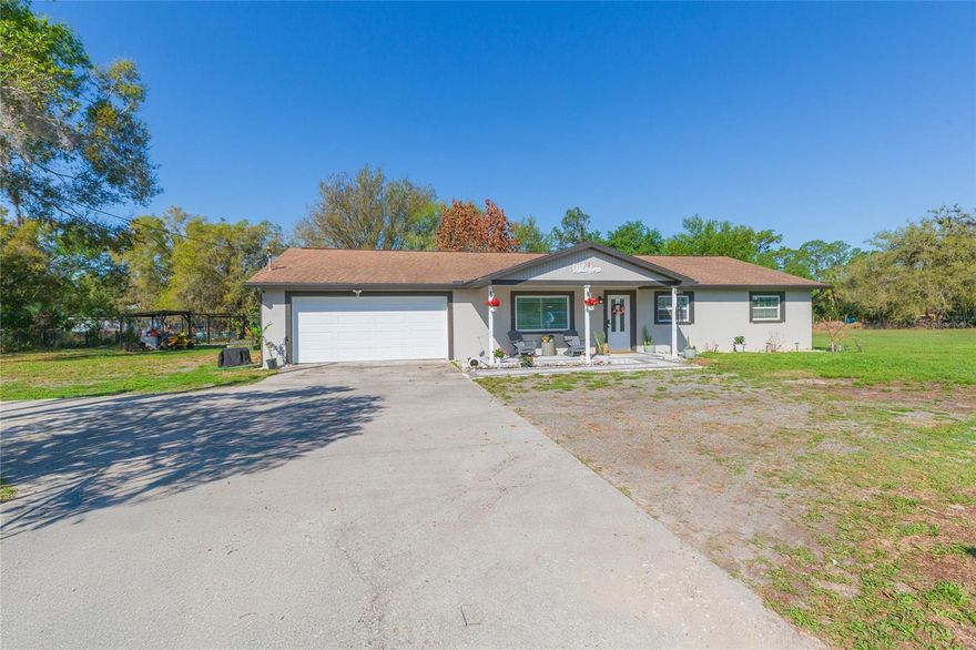 Updated home just minutes from the heart of Wesley Chapel. Situated on over an acre and including two parcels in the sale, this property offers space, privacy, and flexibility. Seller will install a brand-new roof prior to closing, and the home features a brand-new A/C system, providing added peace of mind.

The home offers 3 bedrooms and 2 bathrooms with a comfortable layout including a living room with fireplace, dining area, and functional kitchen with ample cabinetry and counter space. Interior details such as crown molding add a refined touch throughout the main living spaces.  The primary suite features a walk-in closet and ensuite bathroom with dual vanities and a separate shower.

Exterior upgrades include fresh exterior paint (2023), a designed paver patio, and a custom fire pit seating area with pergola. The expansive backyard features a chicken coop, two outdoor structures, an irrigation system with multiple stations, and a generator connection, adding convenience and versatility.

Enjoy the freedom of over an acre of land while still being conveniently located near major roadways, shopping, dining, and everything Wesley Chapel has to offer.