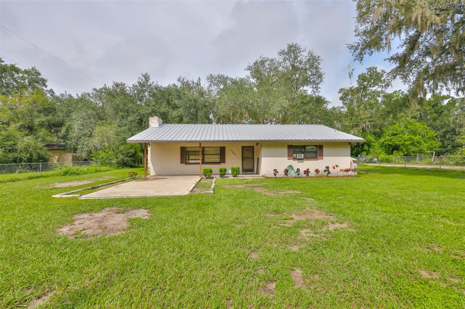 This 2-bedroom, 2-bath home is the perfect fixer-upper for someone ready to create their dream space. Sitting on a large lot just one minute from I-4, it offers both convenience and room to grow. Imagine designing the home exactly the way you want it, with plenty of outdoor space for entertaining, gardening, or simply enjoying the Florida sunshine. The property even includes a chicken coop, ideal for those who love the idea of fresh eggs and a touch of country living. With so much potential inside and out, this is your chance to transform a house into a true home. NO HOA, NO CDD